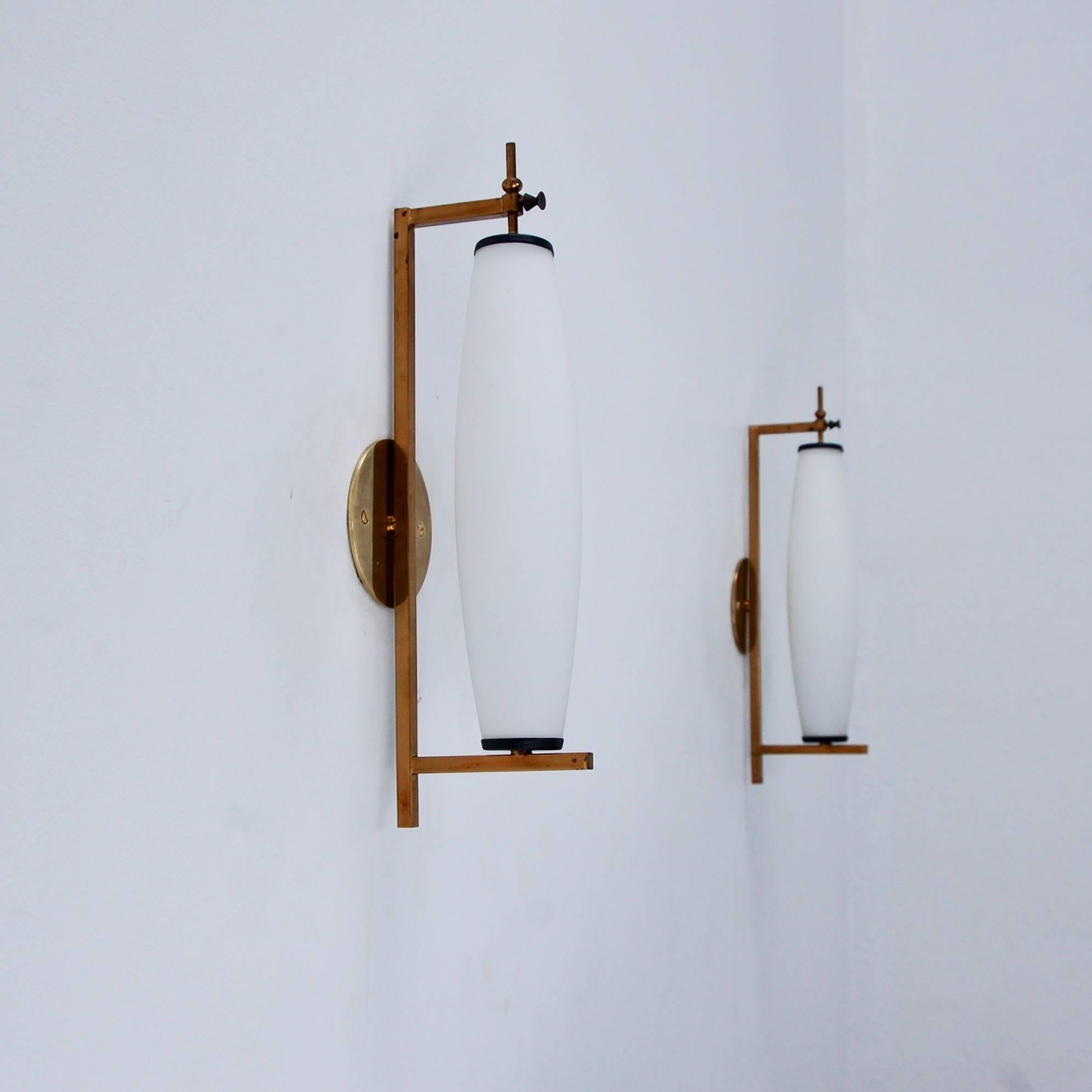 Pair of classic long and tall midcentury brass, aluminum and glass sconces from Italy, with original finish, patina lacquered brass, and glass. Single E12 based socket per sconce. Maximum wattage 75 watts per sconce. Back plate has 2 ¾” center to