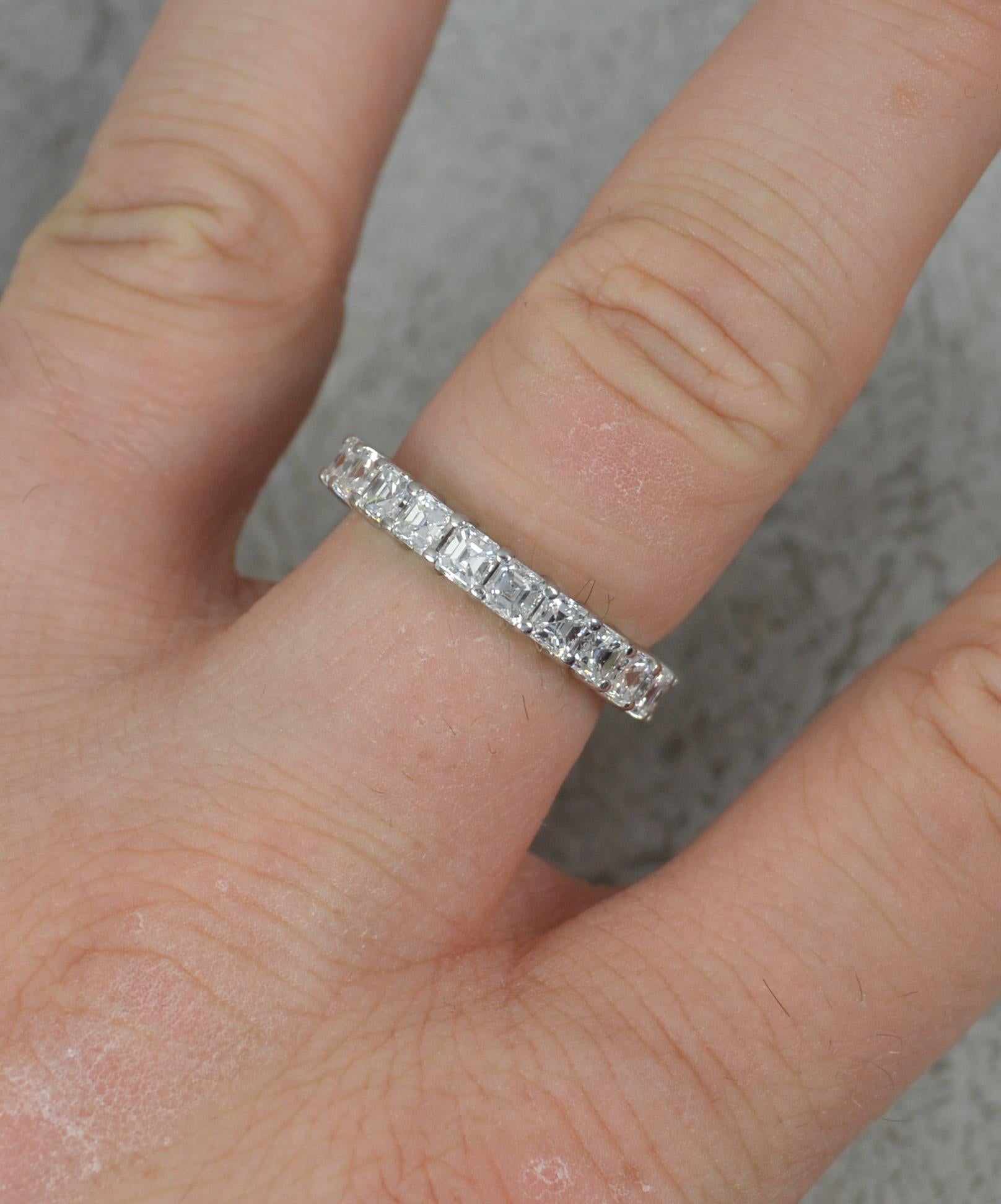 A superb contemporary diamond ring.
Solid 950 grade platinum example.
Designed as a full eternity of carre cut diamonds, 23 diamonds in total. 3.14 carat total weight, as confirmed to the shank. VVS 1 clarity, F colour.
3.6mm wide band throughout.