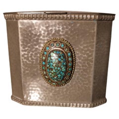 W A Perry an Arts & Crafts Hand Hammered Pewter Box with an Oval Turquoise Jewel