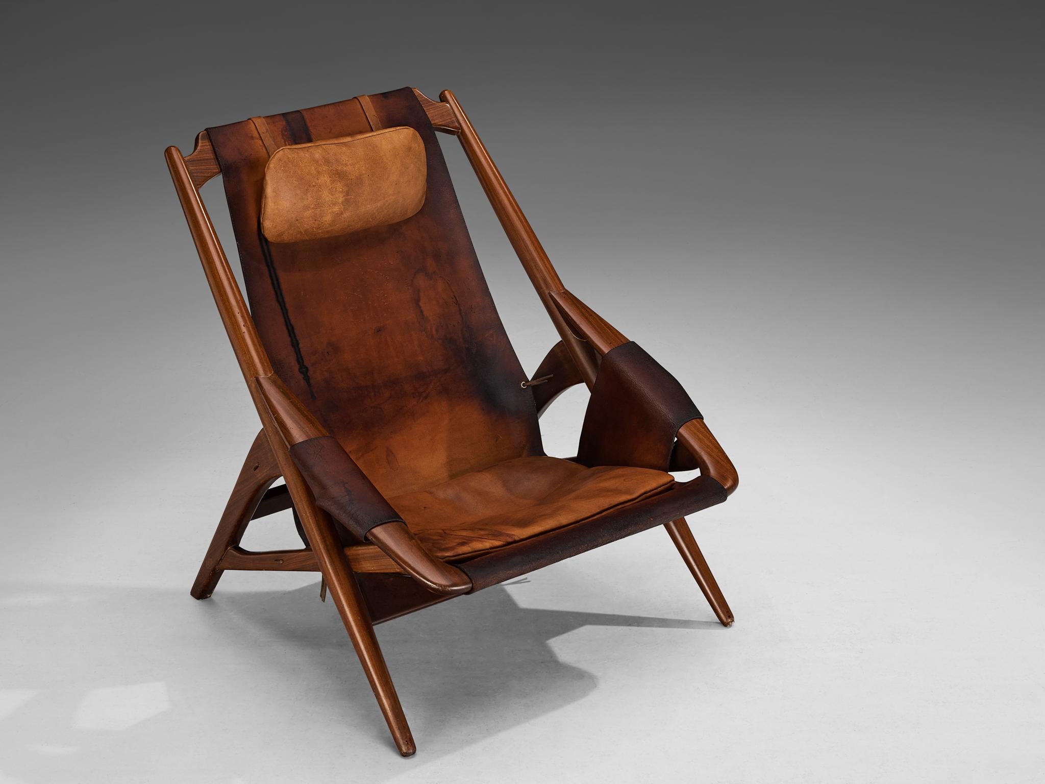 W. Andersag, lounge chair, teak, saddle leather, Italy, 1960s

An exquisite armchair designed by W.D. Ansersag. Its design bears a striking dynamism, highlighted by sharp lines evident in the wooden frame. The chair is reminiscent of robust hunting