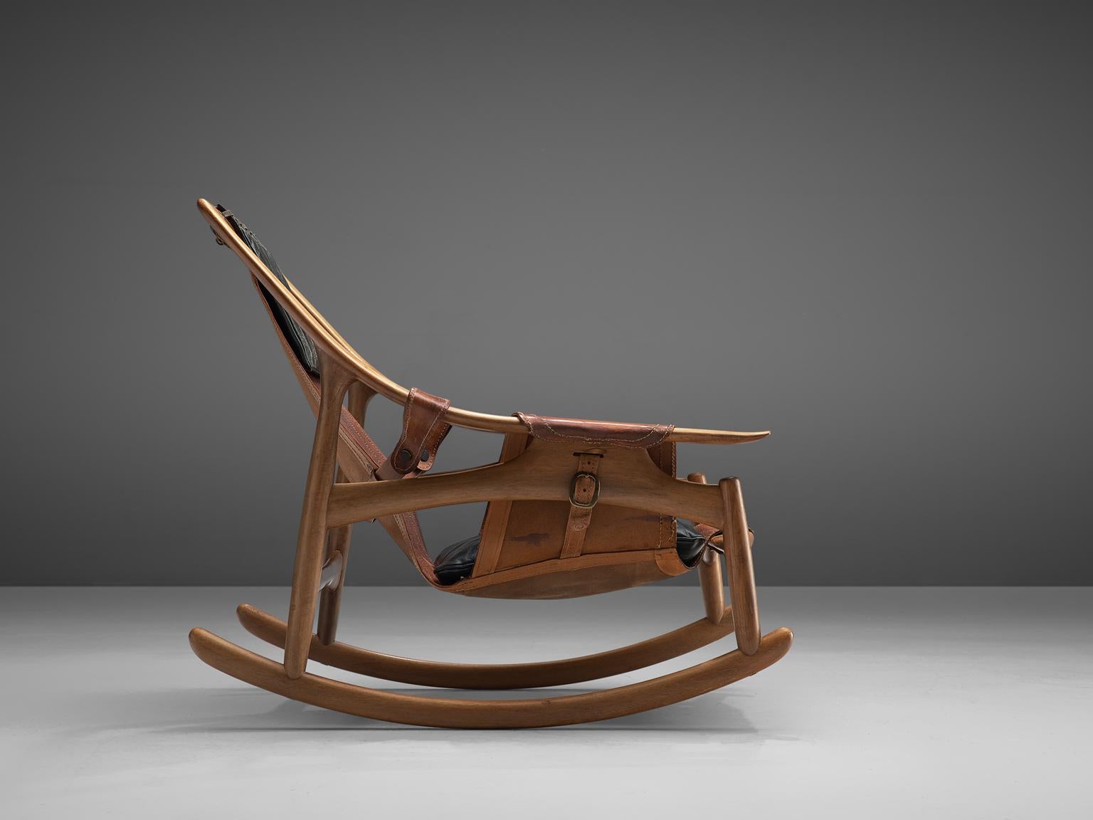 W. Andersag, rocking chair, teak and leather, Italy, 1960s.

This rocking chair by W. Andersag is very dynamic due it's design and shapes. The teak frame shows beautiful lines. The frame and construction reminds of the sturdy hunting chairs. Thick