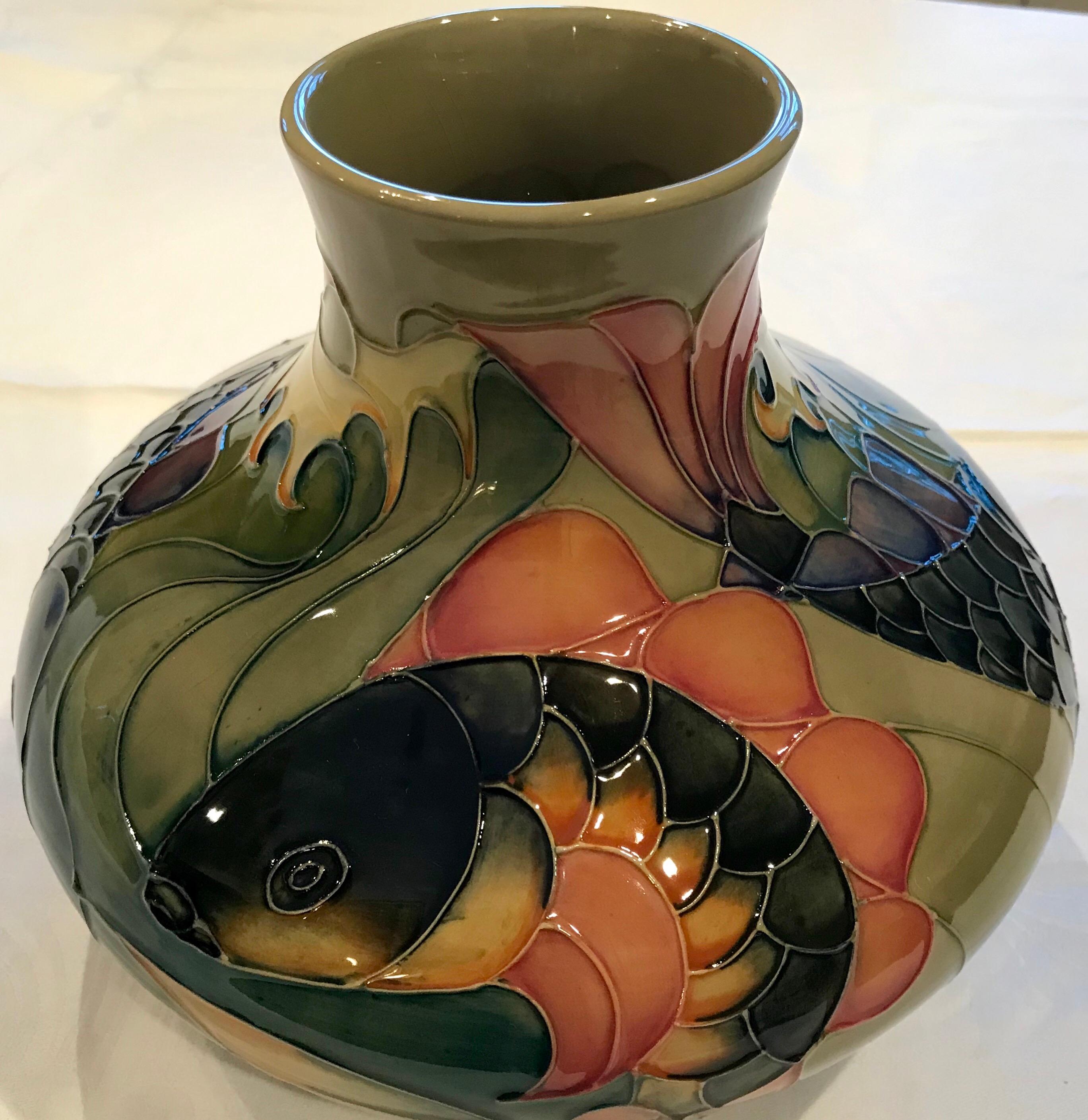 Designed by Sally Tuffin for William John Moorcroft, the carp design was produced in the 1990s in several designs.

A brightly colored pottery vase, depicting a relief design of carp in several poses. Purple, pink, coral, yellow and blue all grace