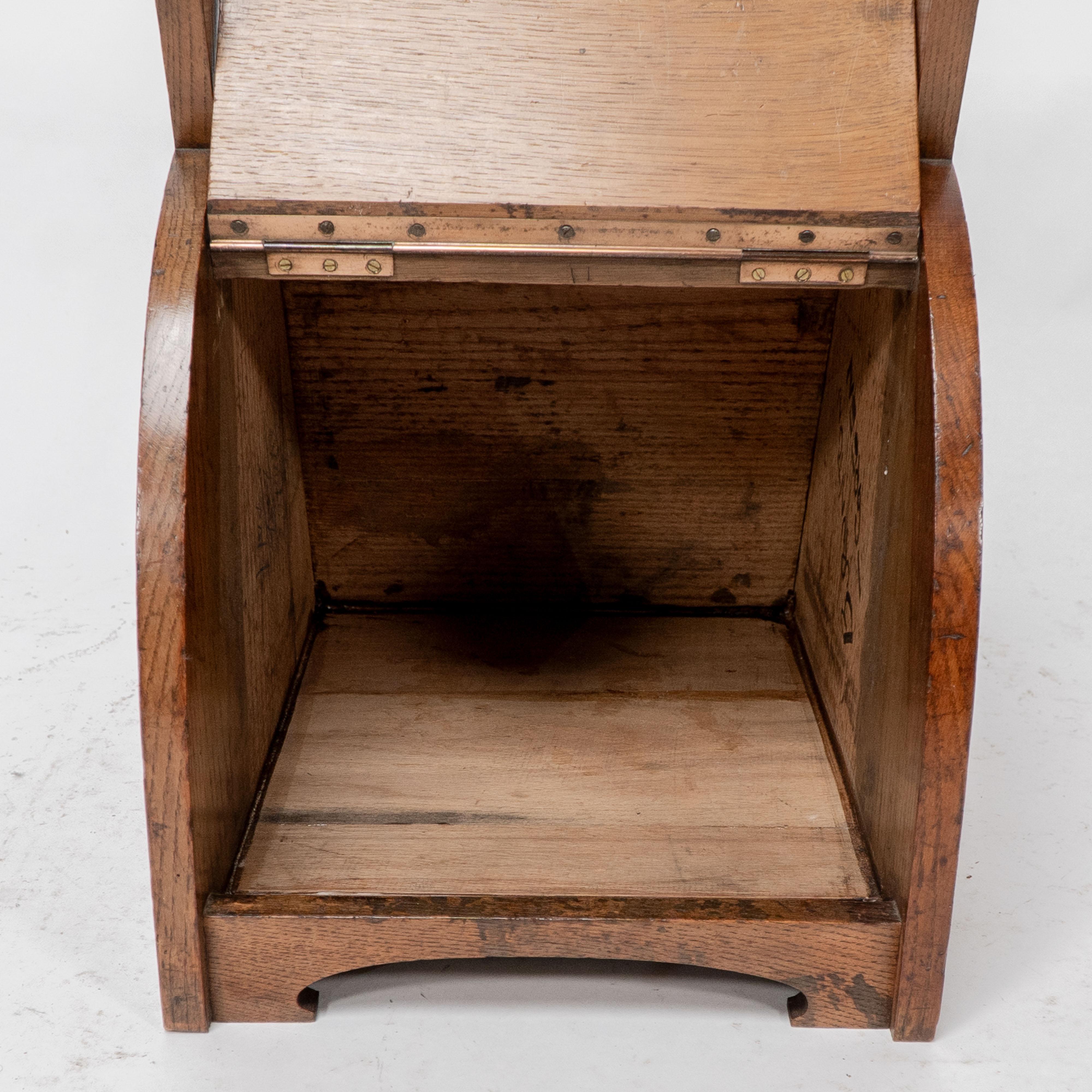 W J Neatby attri. An Arts & Crafts oak coal box with stylized carrying handles For Sale 2