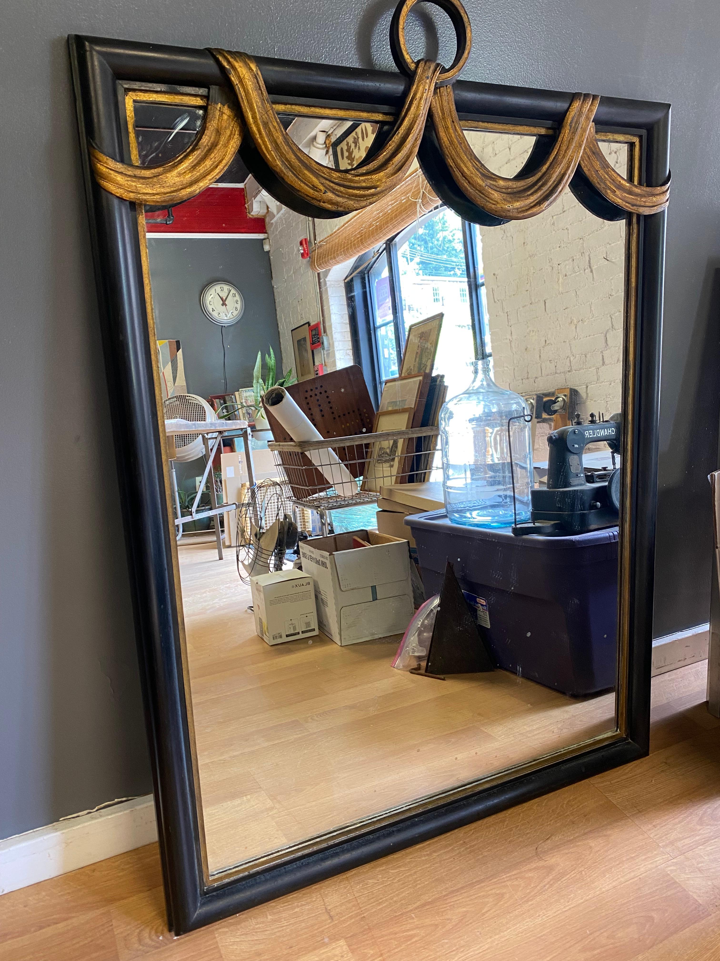 American W. & J. Sloane Hollywood Regency Ebonized and Parcel Gilt Swag Wall Mirror