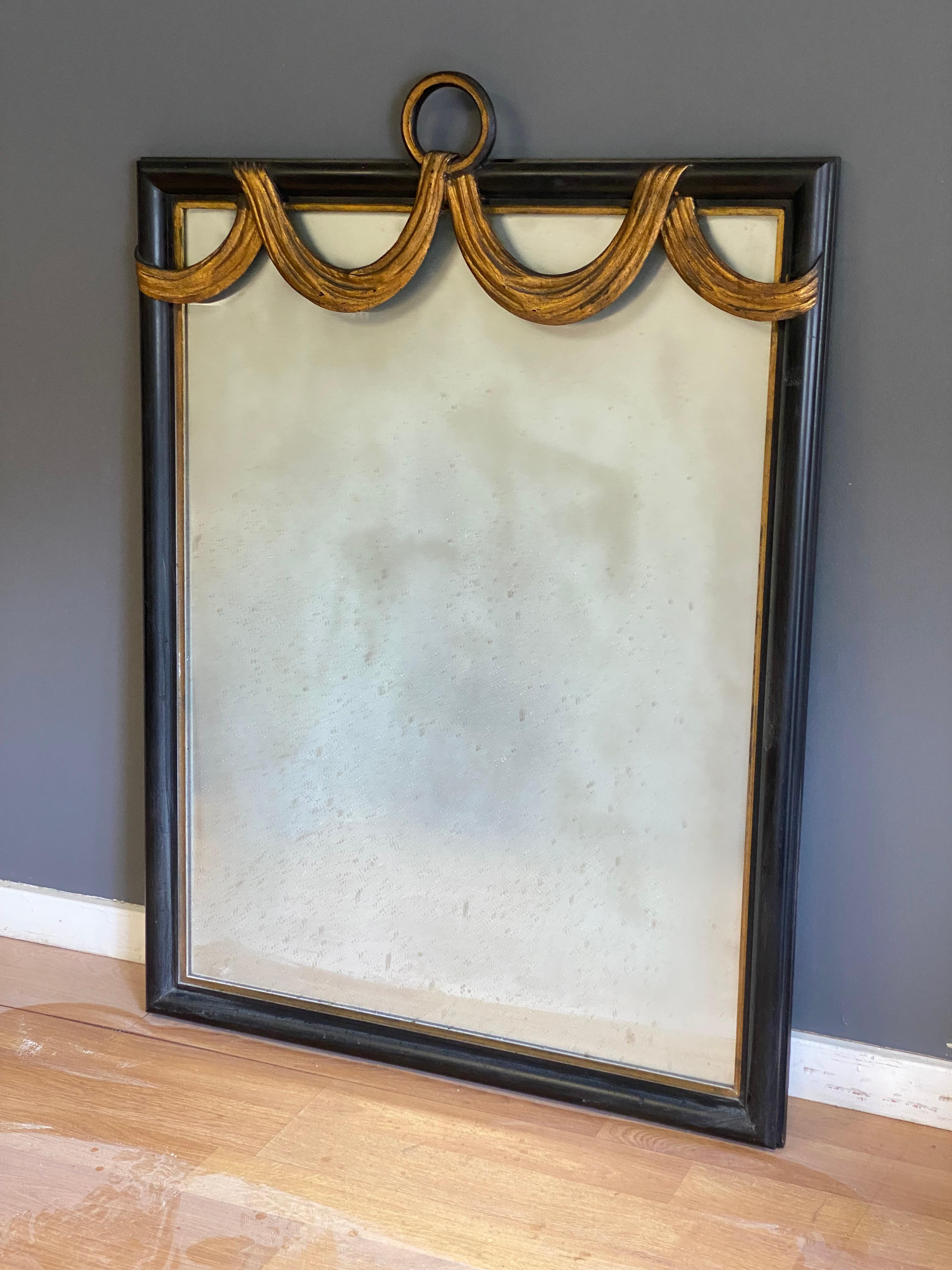 20th Century W. & J. Sloane Hollywood Regency Ebonized and Parcel Gilt Swag Wall Mirror