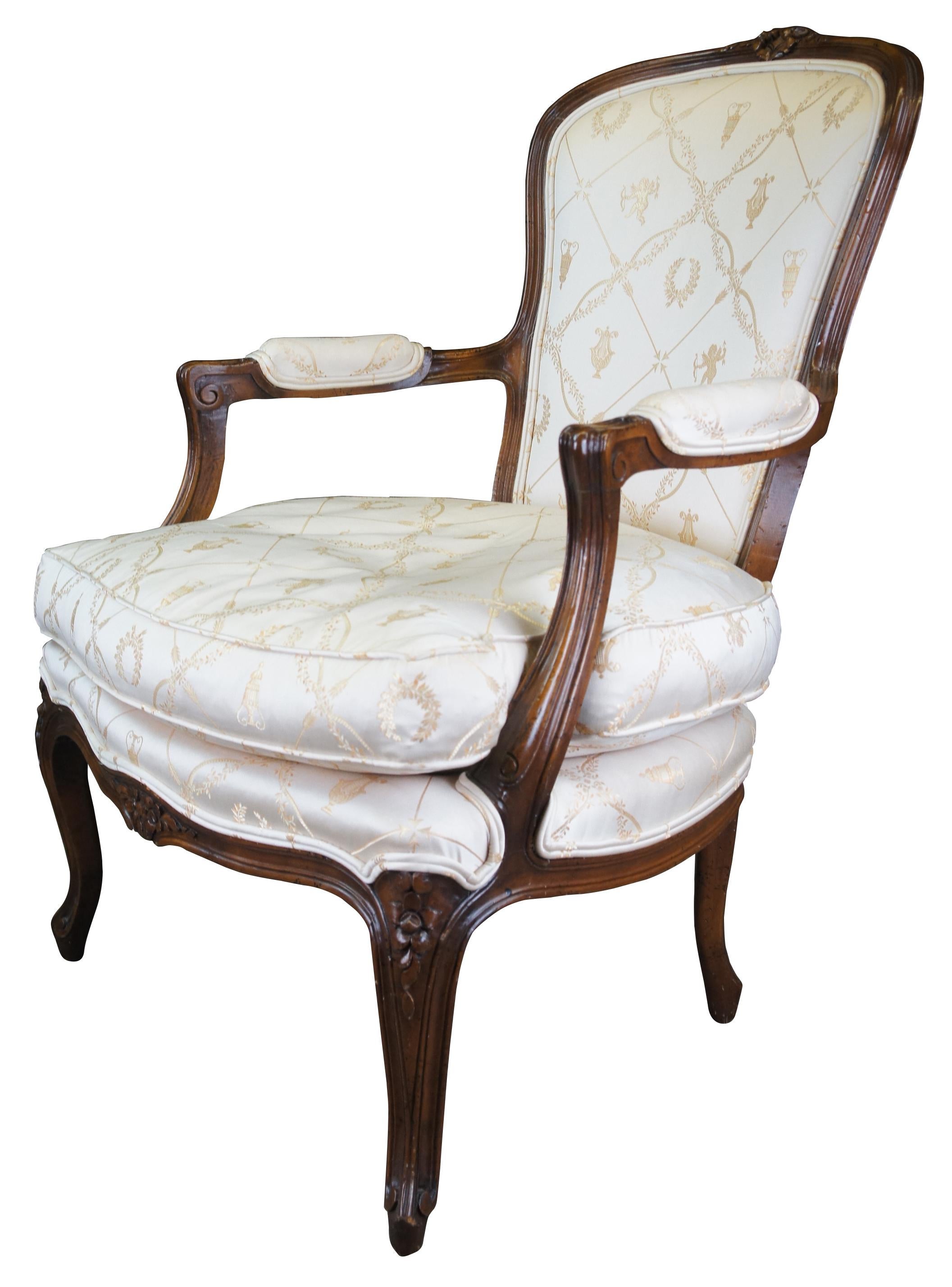 An exquisite French Fauteuil chair by W & J Sloane Inc. Made from naturally distressed walnut with foliate carvings, padded scrolled arms, and cabriole legs. The chair is upholstered in an amazing classical fabric featuring a geometric arrow pattern