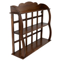 Antique W. R. Lethaby. A Cotswold School Arts and Crafts walnut waterfall wall shelf