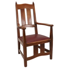 W R Lethaby. A rare Arts & Crafts sculptured oak armchair with shaped arms