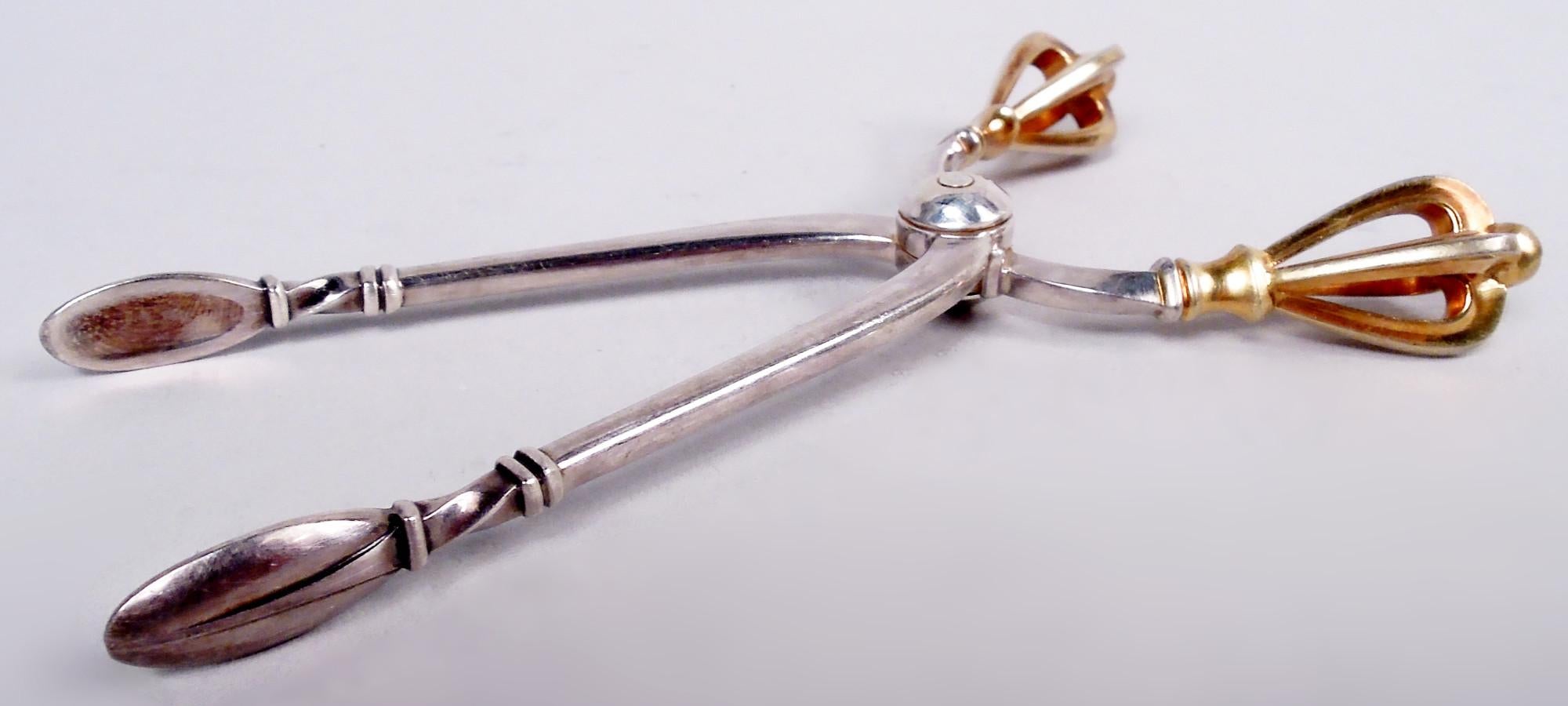 Set of 12 Golden Crown demitasse spoons and sugar nips. Made by W & S Sorensen in Denmark. Rectilinear stems with reeding (spoons) and twisting (nips); open gilt crown terminal—a showy flourish mounted to an austere Danish Modern design. W & S