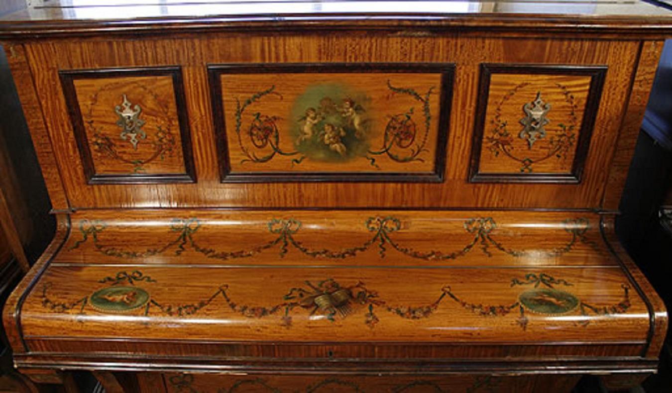A W T Payne upright piano with a hand painted satinwood case. Hand painted with musical instruments, cherubs, flowers and swags
Requires restoration 

Free first tune-UK Only 
Free piano stool 
Free delivery to any ground floor residence within