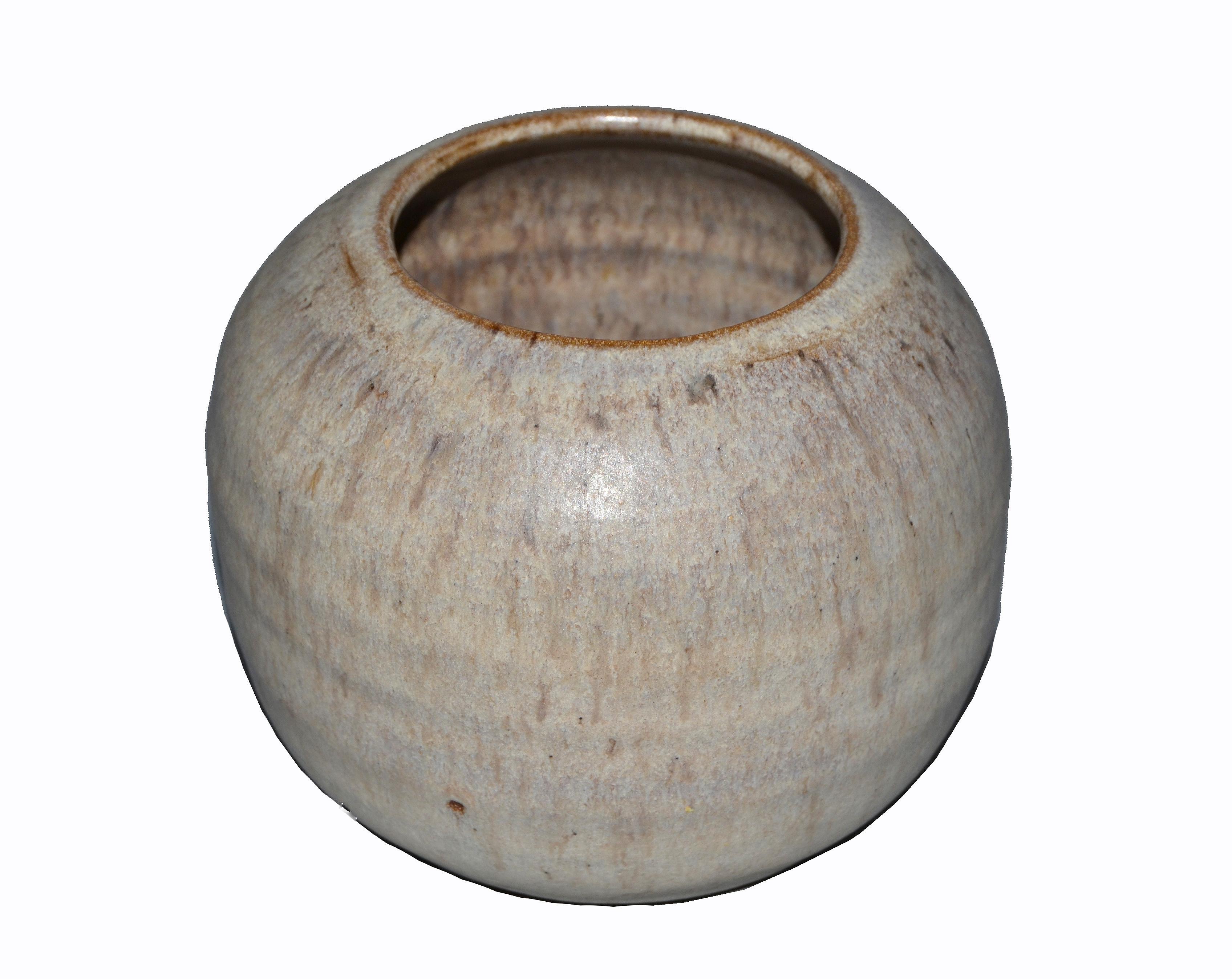 W. Young Mid-Century Modern handcrafted beige and brown pottery earthenware round vase, vessel or bowl.
Underneath engraved by the artist with W. Young.
Simple but lovely.