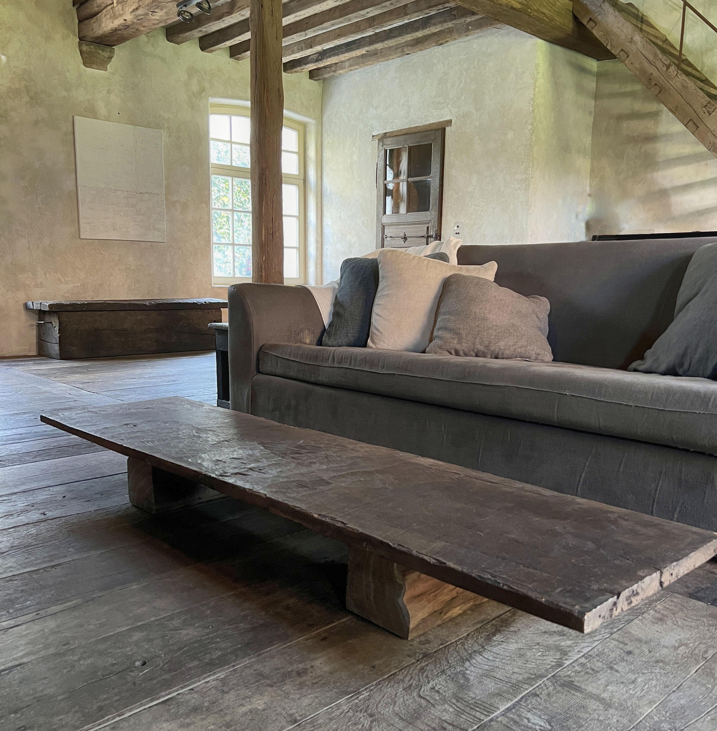 This coffeetable was made in our workshop starting from a one slab 19th century walnut top from the Pyrinee region. The bases were made from reclaimed slabs of old oak.