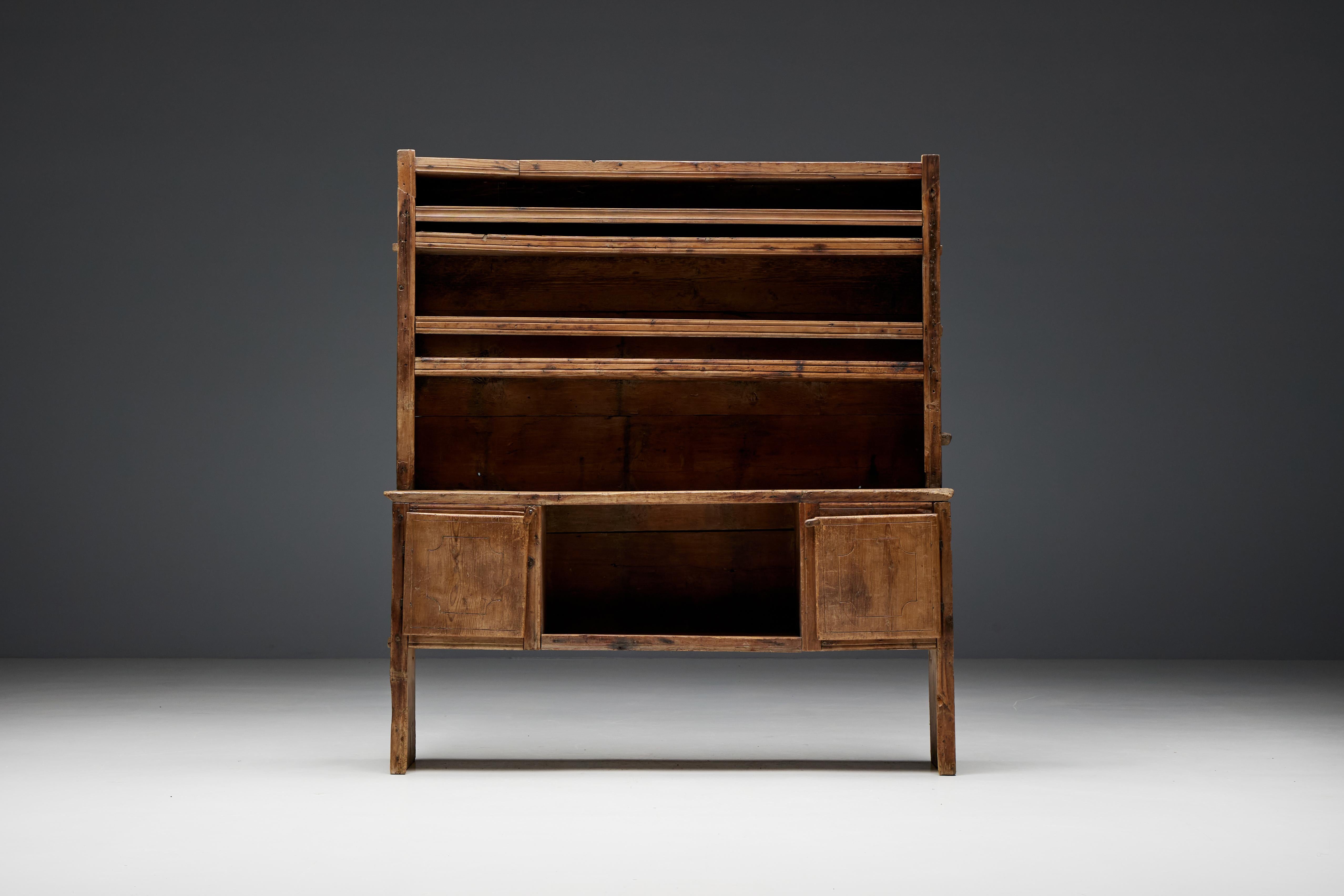 Charming 19th-century French wabi sabi dresser with beautiful imperfections and rich patina. The lower section features two panelled doors providing closed storage space, alongside an open shelf ideal for displaying cherished items. The upper part