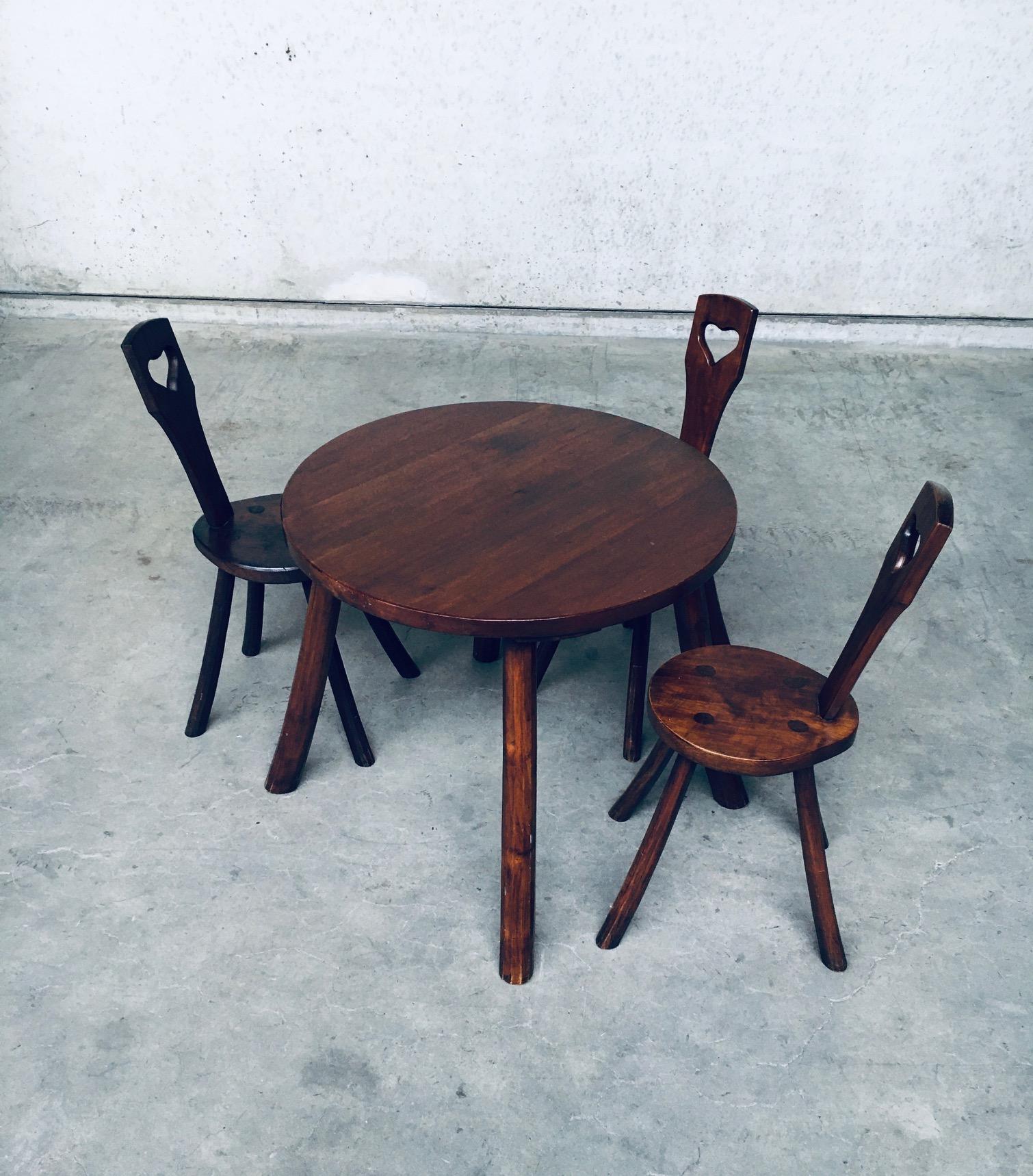 Vintage Wabi Sabi Style Rustic French Design Handcrafted Solid Oak Round Dining Table with 3 matching dining chairs. Made in France in the 1940's. Solid oak handmade round table on 4 carved legs with 3 matching chairs. The chairs have a rounded seat