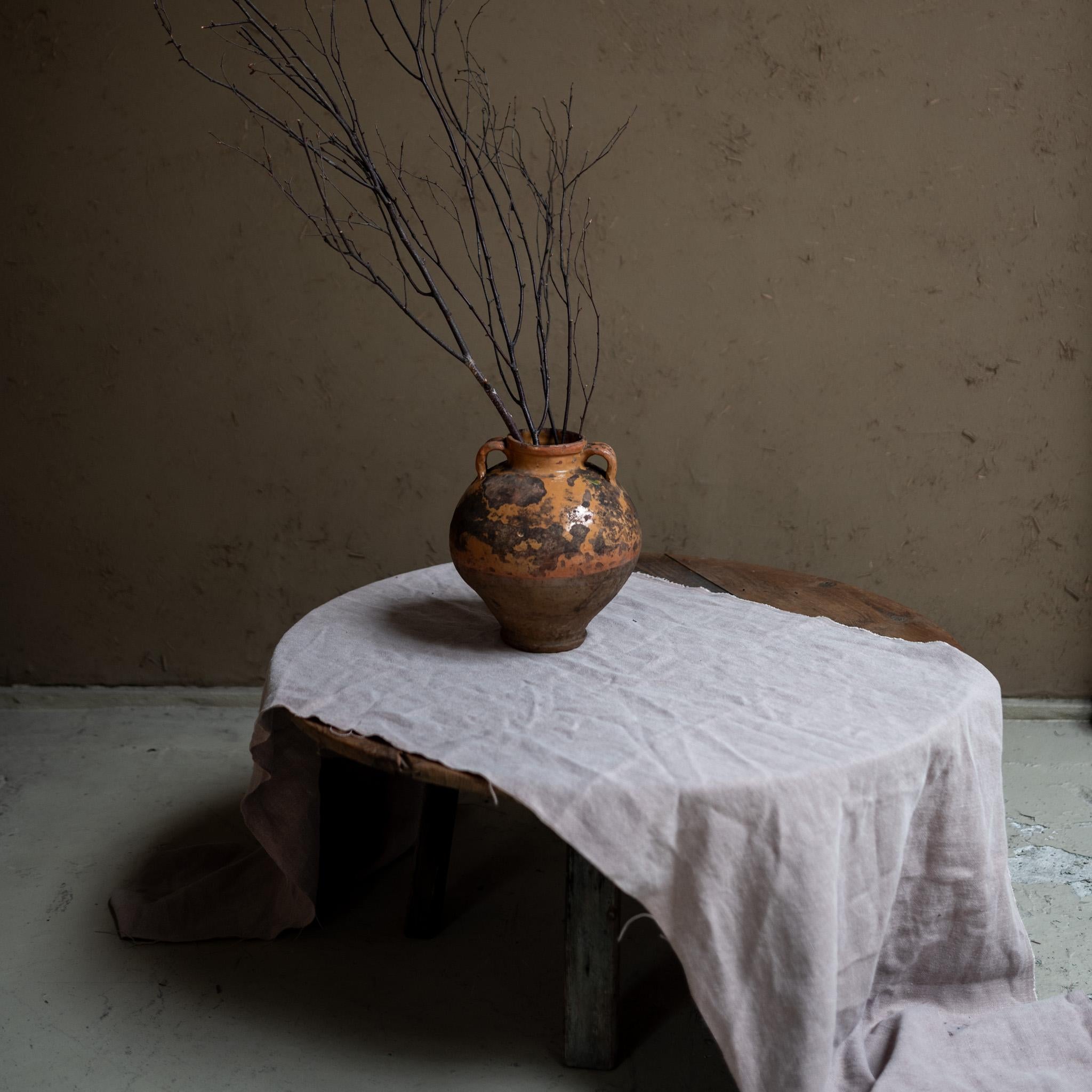 This beautiful clay vase, dating back to the 19th century, is a wonderful example of craftsmanship from its time. Made from high-quality clay, it features unique textures and colors that give it character and charm.

This weathered Vessel boasts a