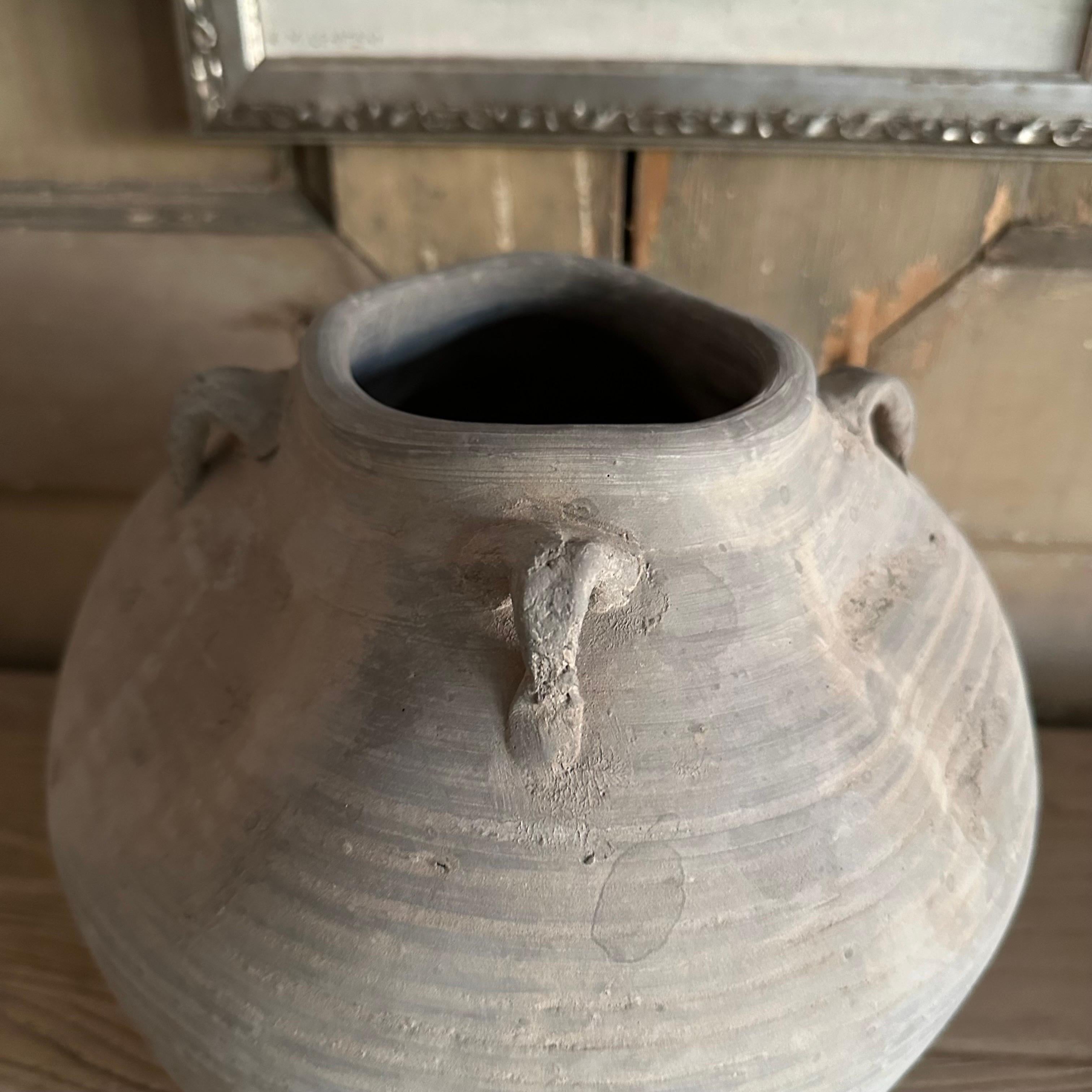 Stone / Clay Pottery in the wabi sabi style
Its distorted shape makes it a beautiful piece of art.
Use by itself or fill with flowers.
Size: 9.75” h x 10.5”d 
Opening 3.75”
1211-1
-Multiple vases available you will be receiving one similar from our