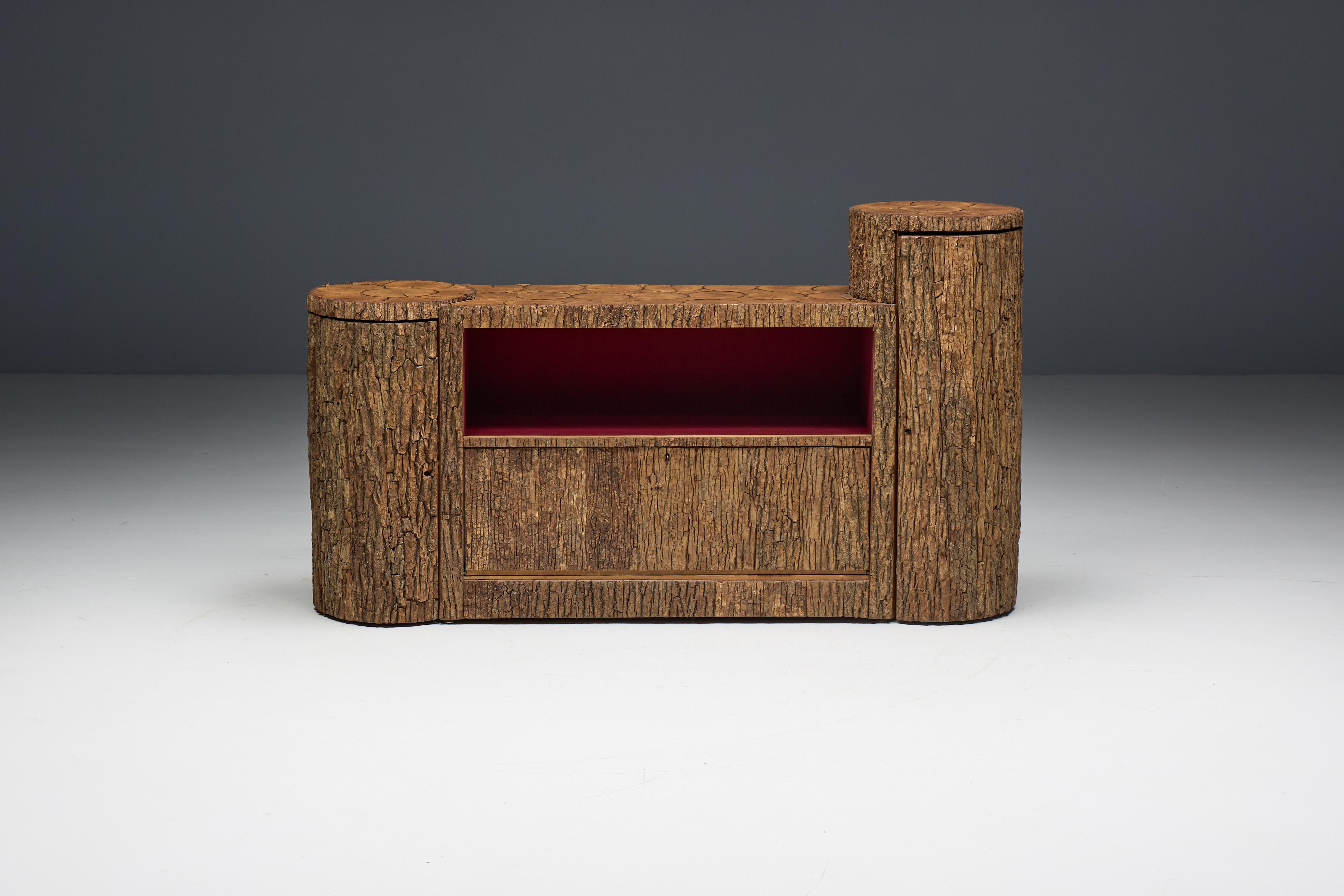 Primitive bark sideboard, crafted in Switzerland during the 1950s. Its exterior, covered in authentic bark and tree trunk elements, evokes the raw beauty of nature, while the bold red laminated shelving inside adds a modern twist. This credenza