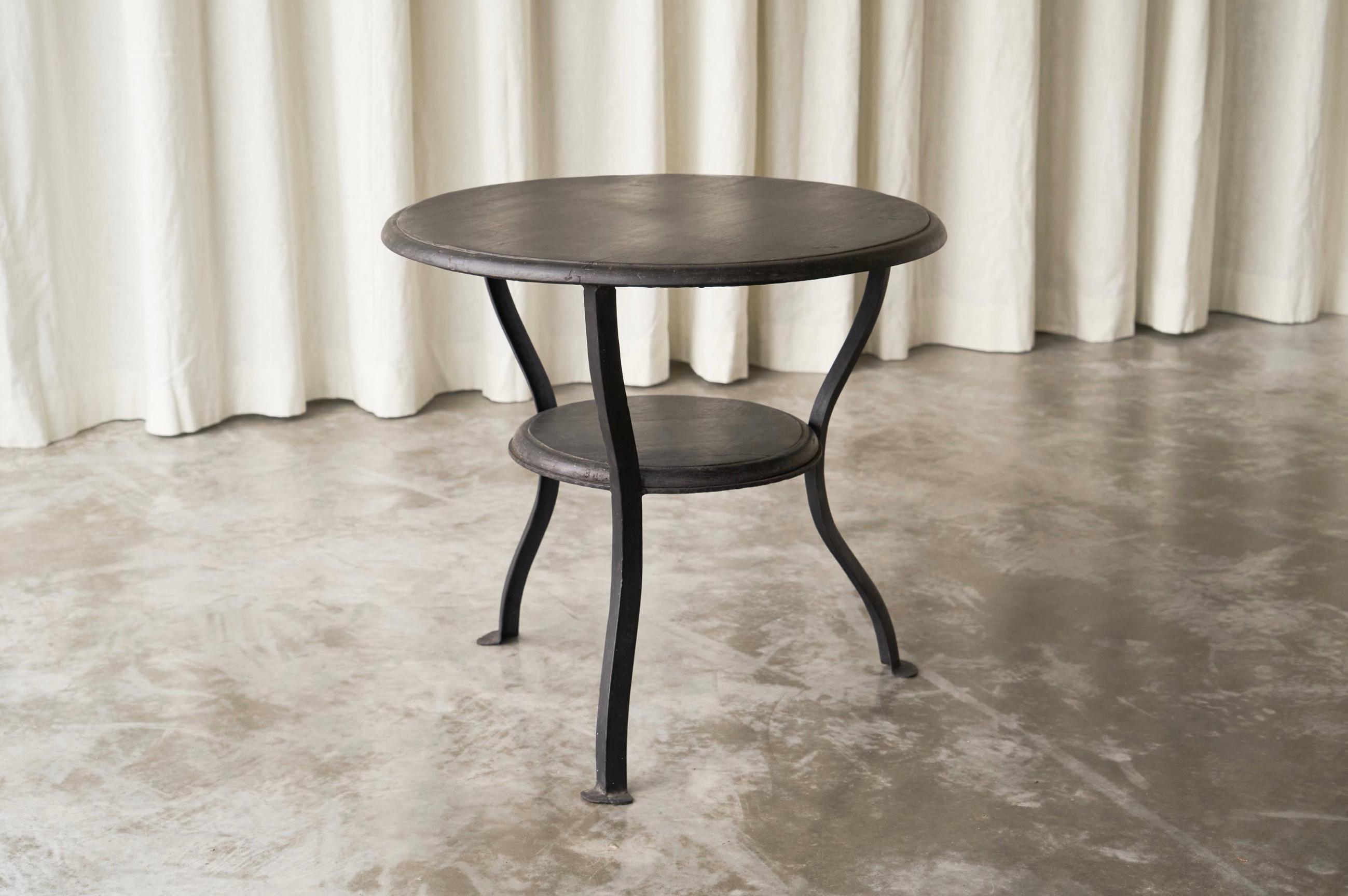 Wabi Sabi Side Table in Hand Forged Metal and Stained Wood, 1920s.

This wonderful 1920s Wabi Sabi side table most likely origins from France. It is well made in hand forged and blackened steel, combined with dark stained solid wood. It features two