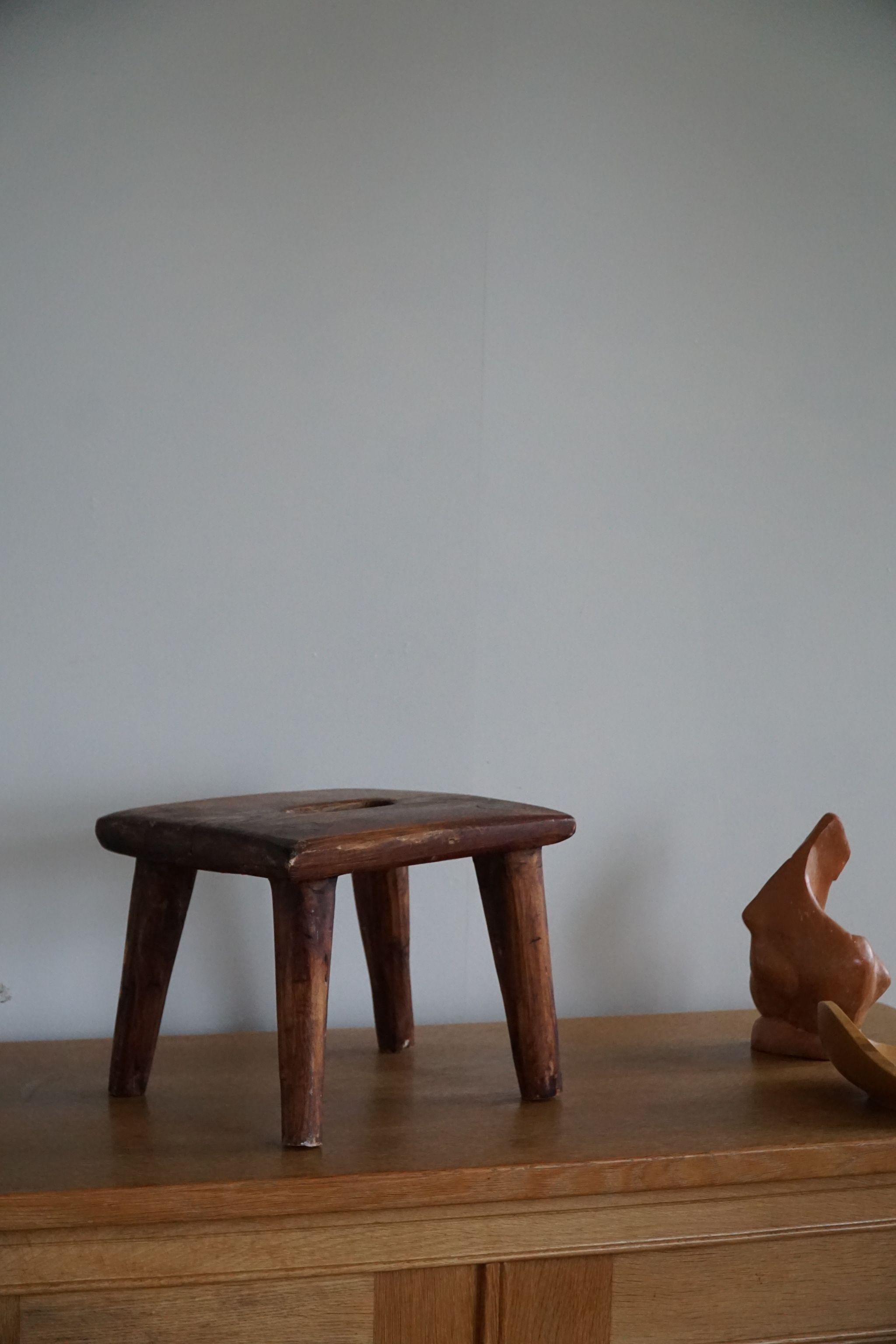 Decorative Scandinavian stool in solid pine. Hand carved by a Danish cabinetmaker in 1960s. An overall fine patina in this vintage object.

This modern stool will fit in many types of home decor. Perfectly suited for a Classic, Wabi Sabi,