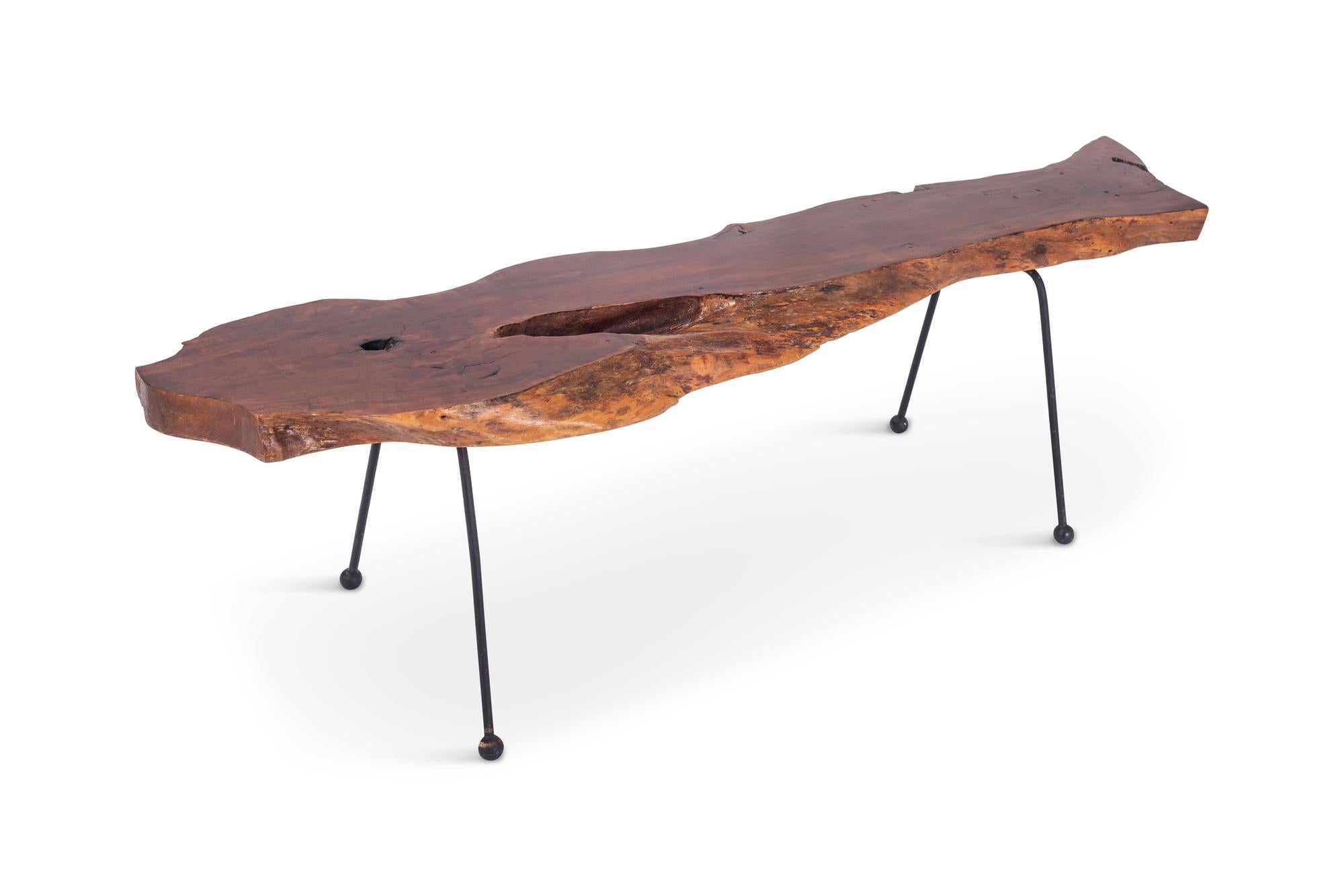 Walnut coffee table in “wabi sabi” style with a beautiful natural shaped tabletop, showing great curves and markings, giving this unique table a wonderful natural expression. 

The tabletop is mounted on four thin black lacquered metal legs with