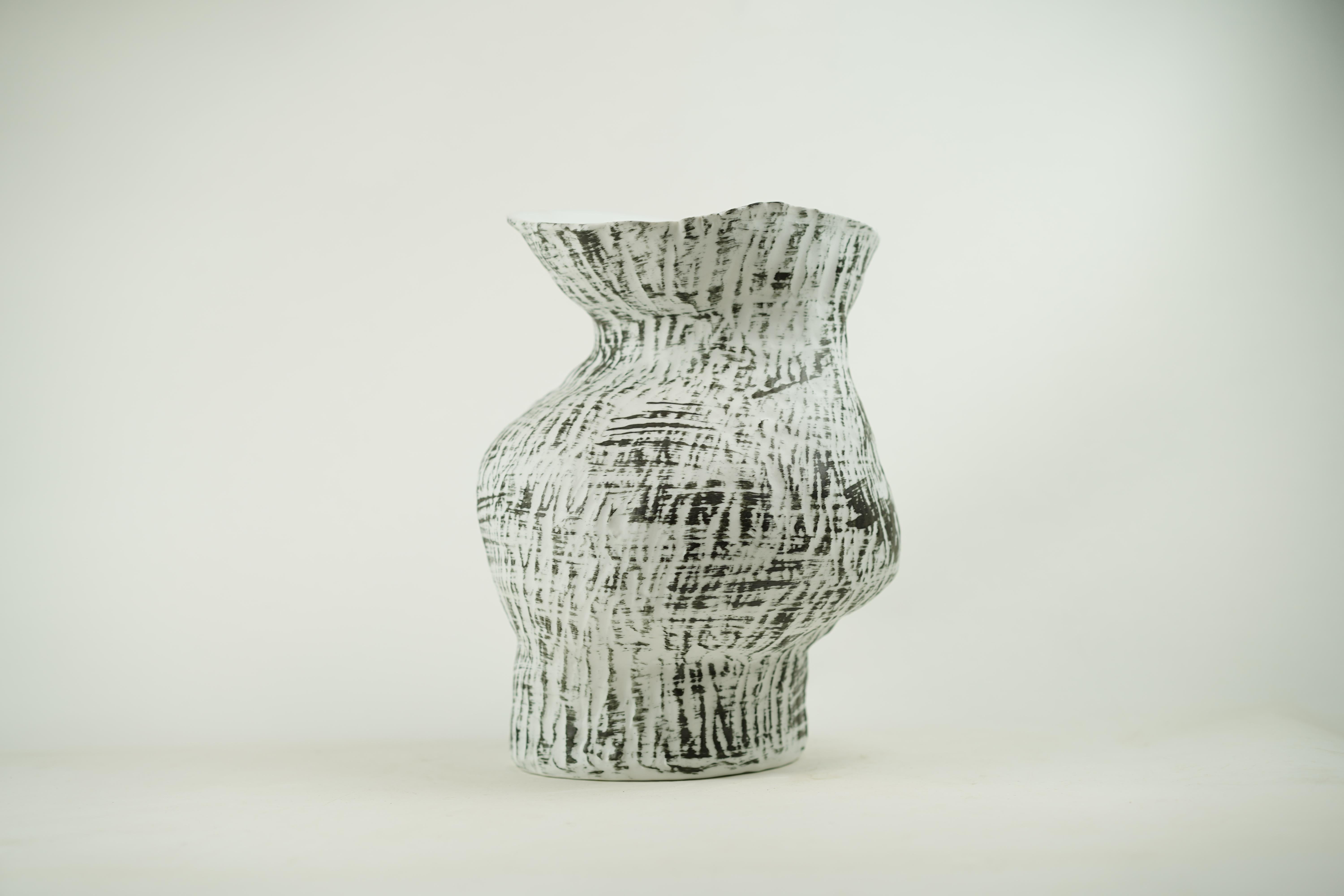 The Surface vase embodies organic landscapes that naturally bend and crease. Its asymmetrical curves feel wholesome because they speak to wabi-sabi's appreciation for the unrefined. Rustic and raw, it is crafted without tools, preserving the art of