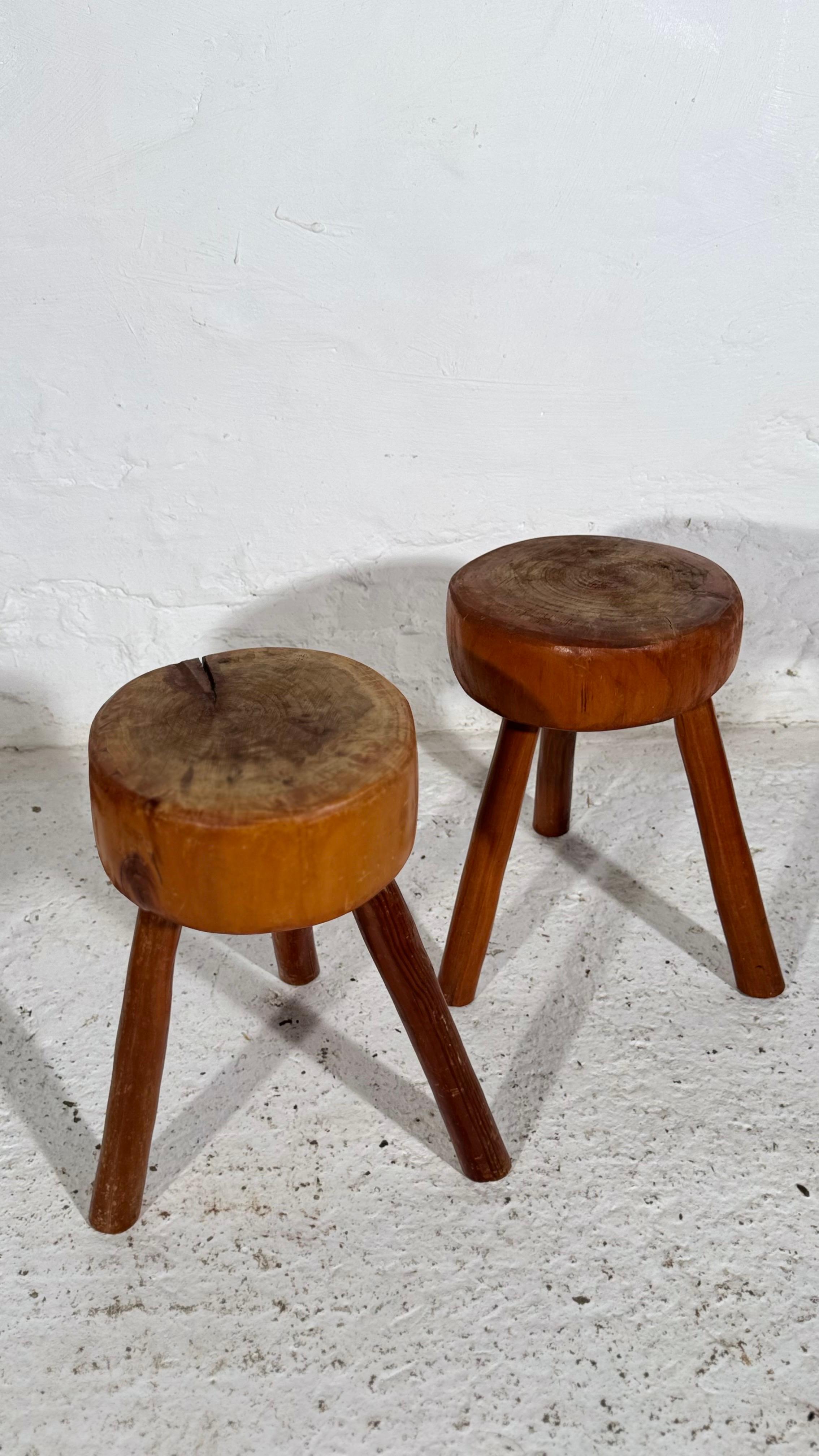 Set of two Wabi Sabi tripod stools, 1960s, Made in France of solid wood.A great brutalist object, perfect for the modern interior. A warm colour and patina that pair well with the minimalist scandinavian lifestyle. Scandinavian design is
