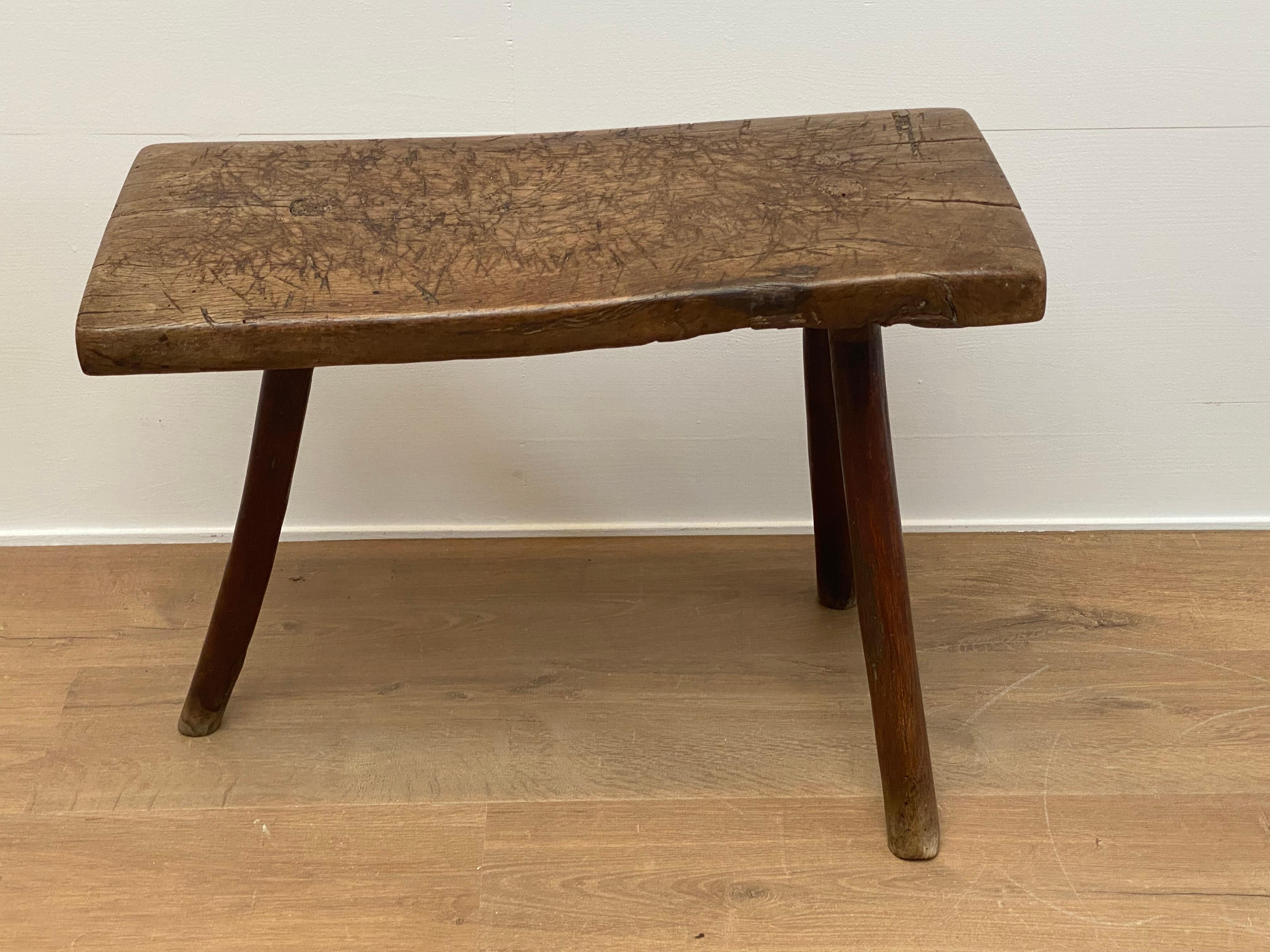 Rustic, Antique stool or Tabouret from Spain,
Catalunia from around 1920,
good old patina of the Chestnut wood, 
old carvings in the wood, the stool was used in the Spanish Kitchens.