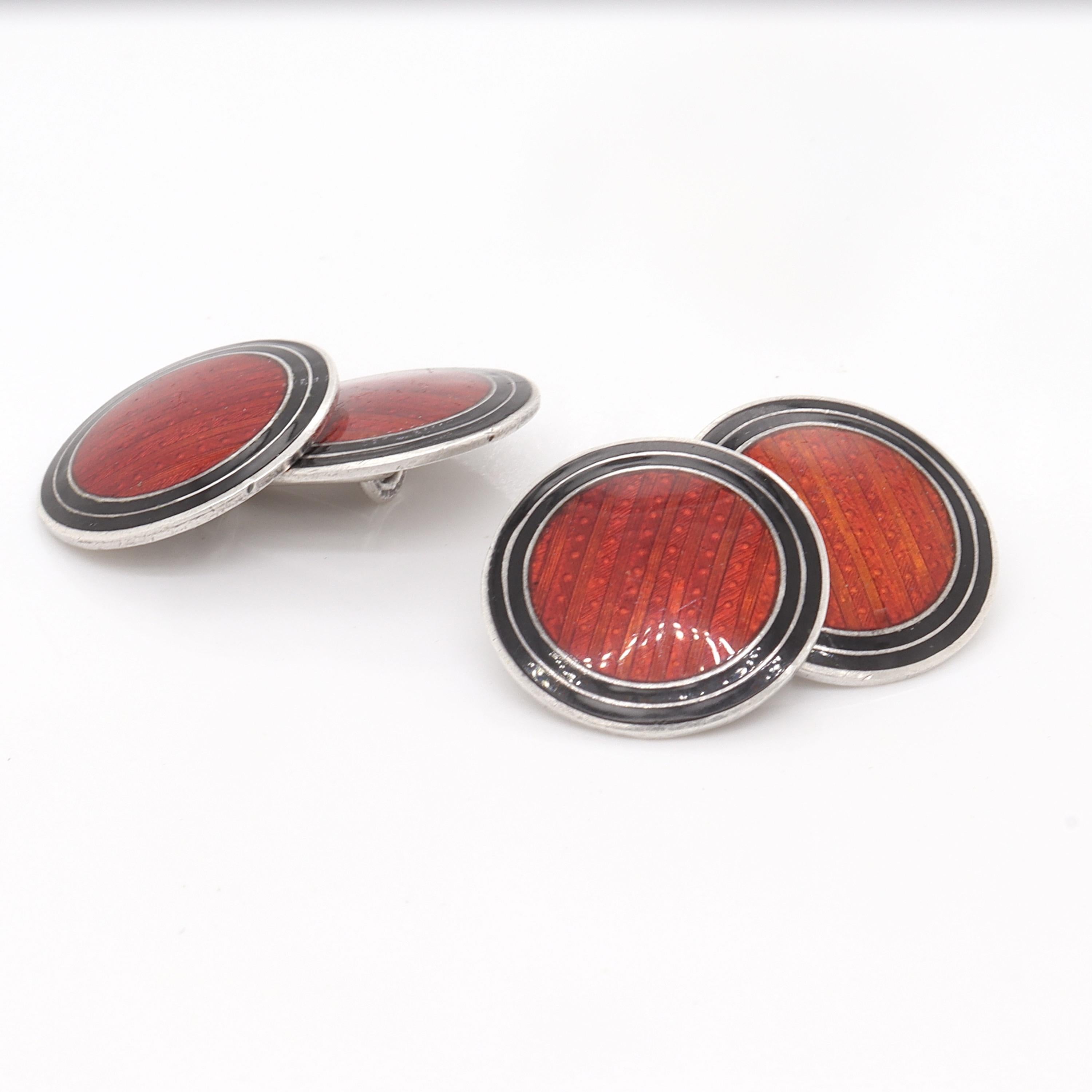 A fine pair of American Art Deco cufflinks.

In sterling silver.

With red or crimson guilloche enamel centers with double ring black enamel borders.

By Wachenheimer Brothers, Inc. of Providence, RI. 

Simply a wonderful pair of Art Deco