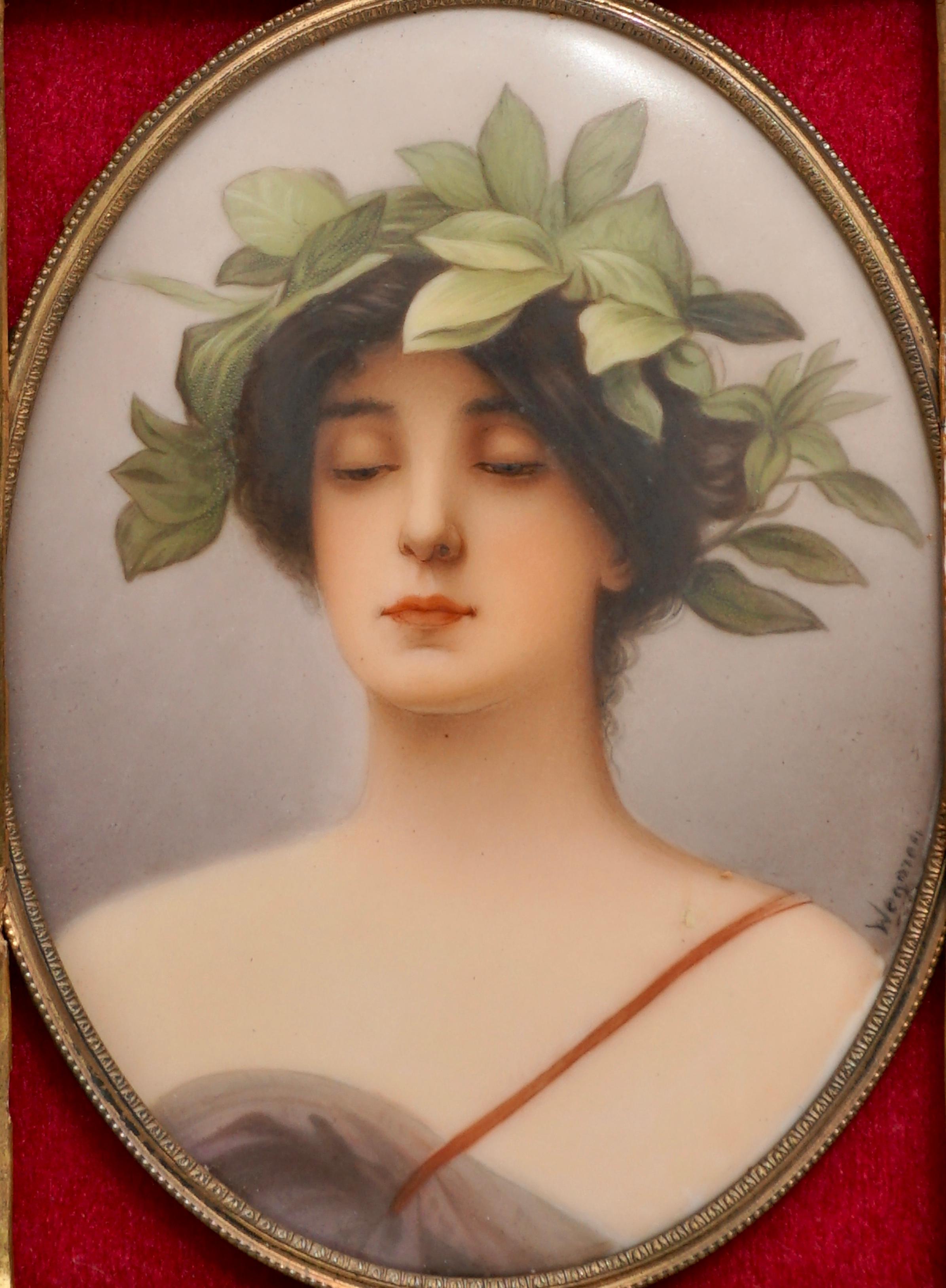 Shoulder length portrait of young lady in classical gown with laurel leaf wreath in hair.
Manufacturer: C.M. Hutschenreuther
signed lower right “Wagner” 
Stamped on back “12” over circle with “CR” with painted titled “Daphne”
 
Oval Porcelain