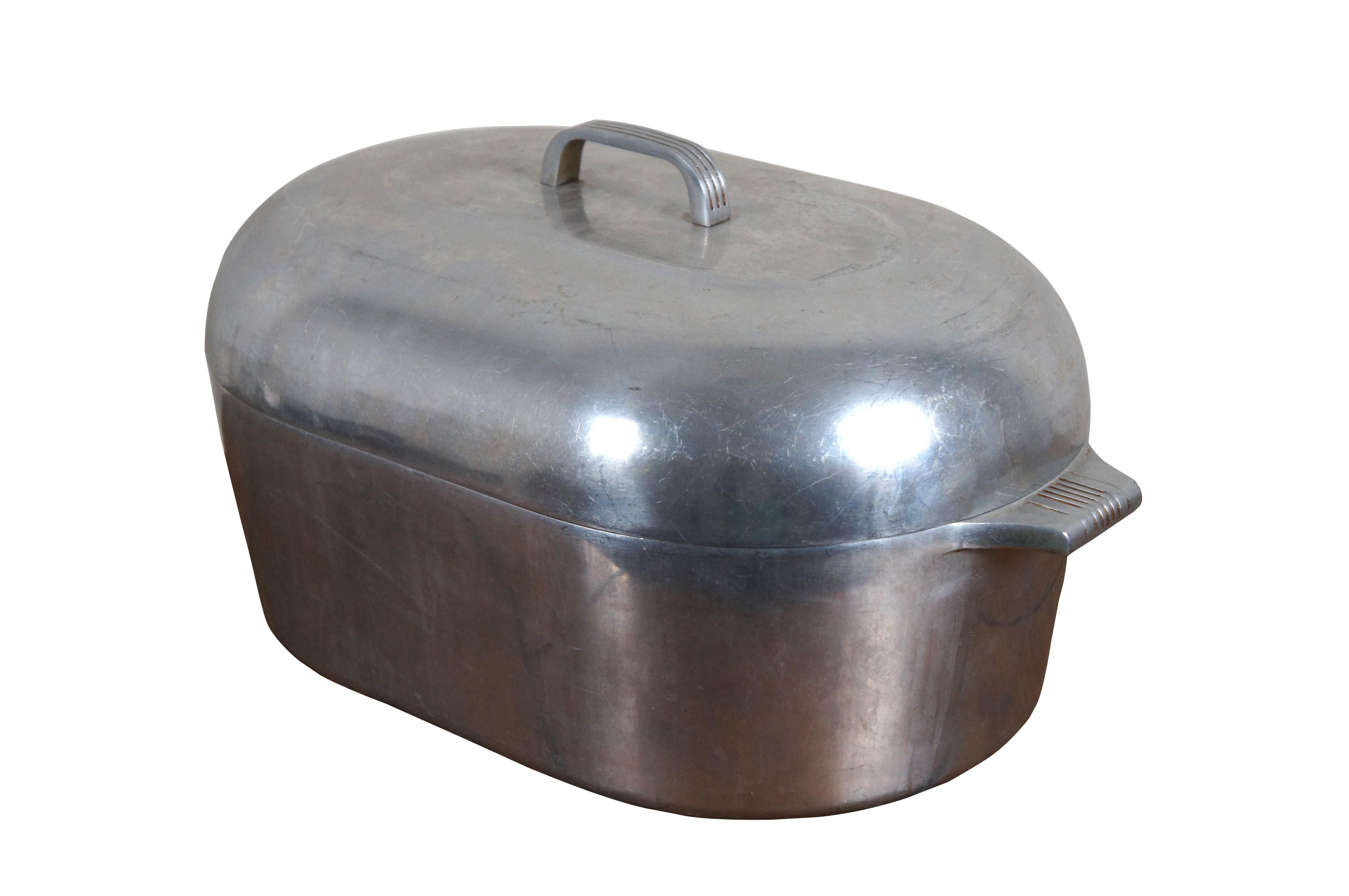 Early to mid 20th century Wagner Ware Magnalite number 4269 extra large, 17 quart aluminum turkey roaster / dutch oven featuring simple art deco styling on the base and lid handles.

