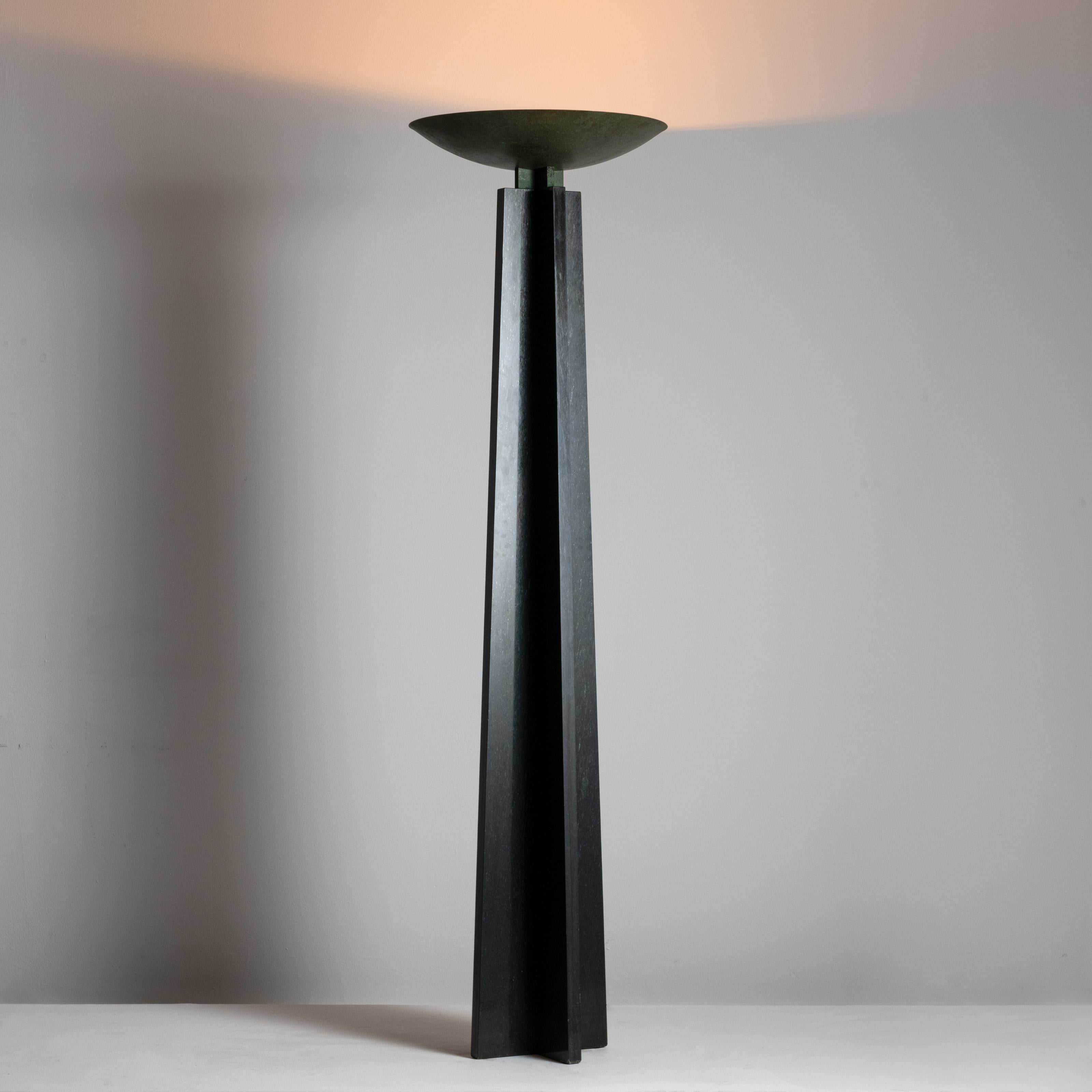 Wagneriana marble floor lamp by Lella and Massimo Vignelli. Designed and manufactured in Italy, 1986. A monolithic black marble floor lamp adorned with a brass bowl-shaped shade. The shade has been expertly patinated with a verde finish. Floor lamp