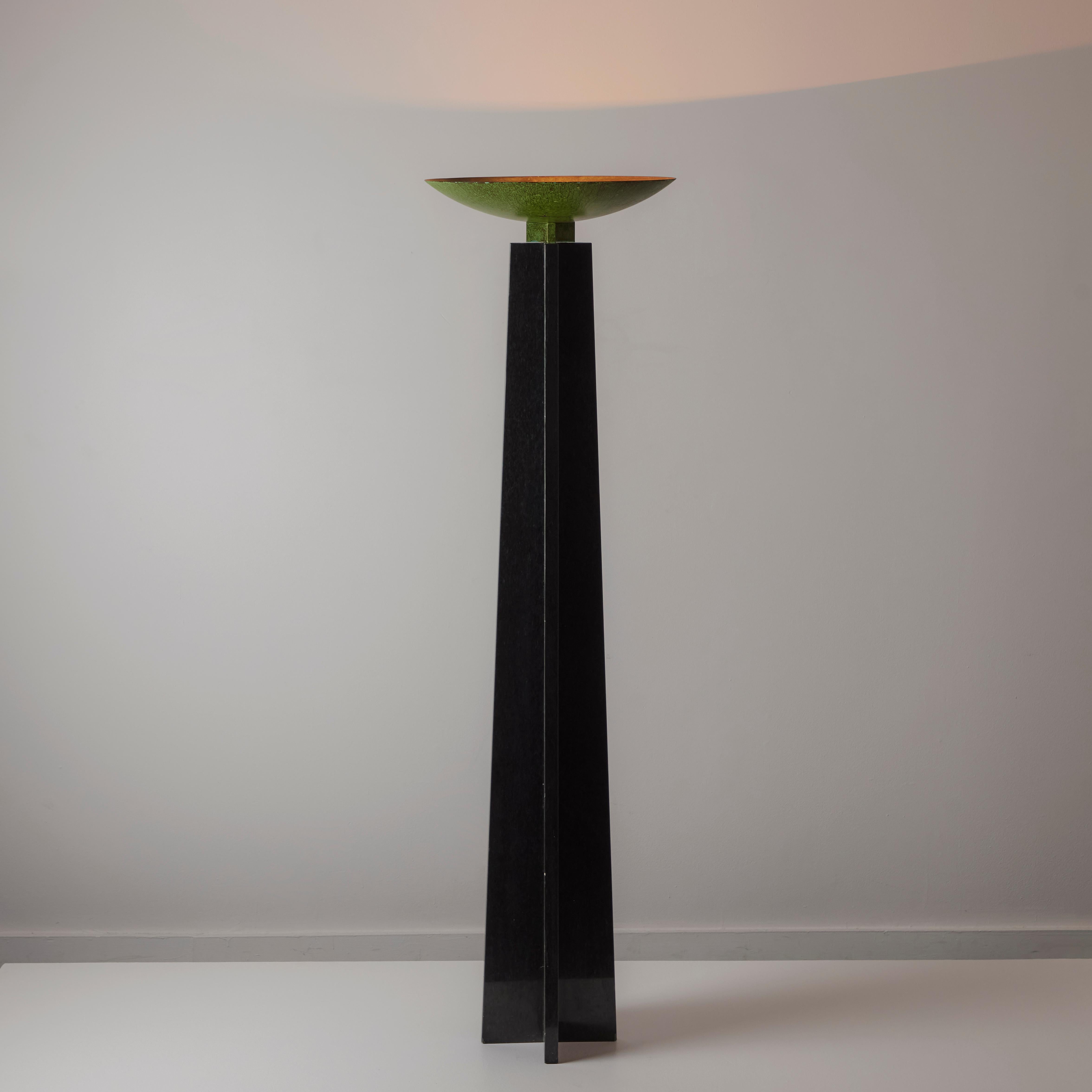 'Wagneriana' marble floor lamp by Lella and Massimo Vignelli. Designed and manufactured in Italy, 1986. A monolithic black marble floor lamp adorned with a brass bowl-shaped shade. The shade has been expertly patinated with a verde finish. Floor