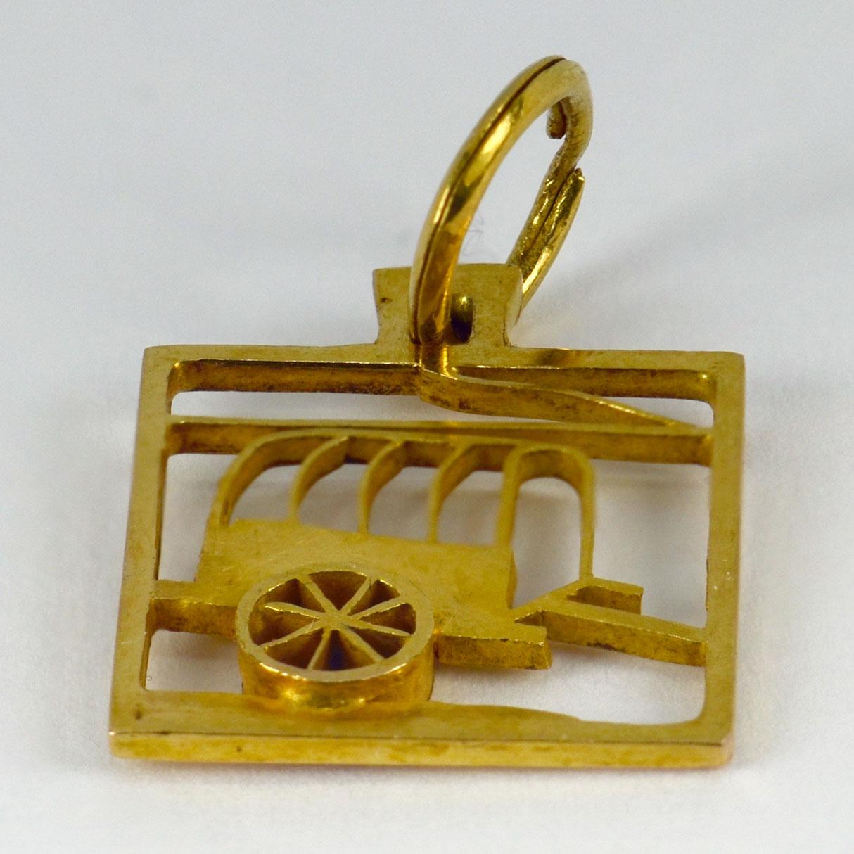 An 18 karat (18K)  yellow gold square charm pendant designed as a wagon. Unmarked but tested as at least 18 karat gold.

Dimensions: 1.9 x 1.5 x 0.2 cm (not including jump ring)
Weight: 1.85 grams
