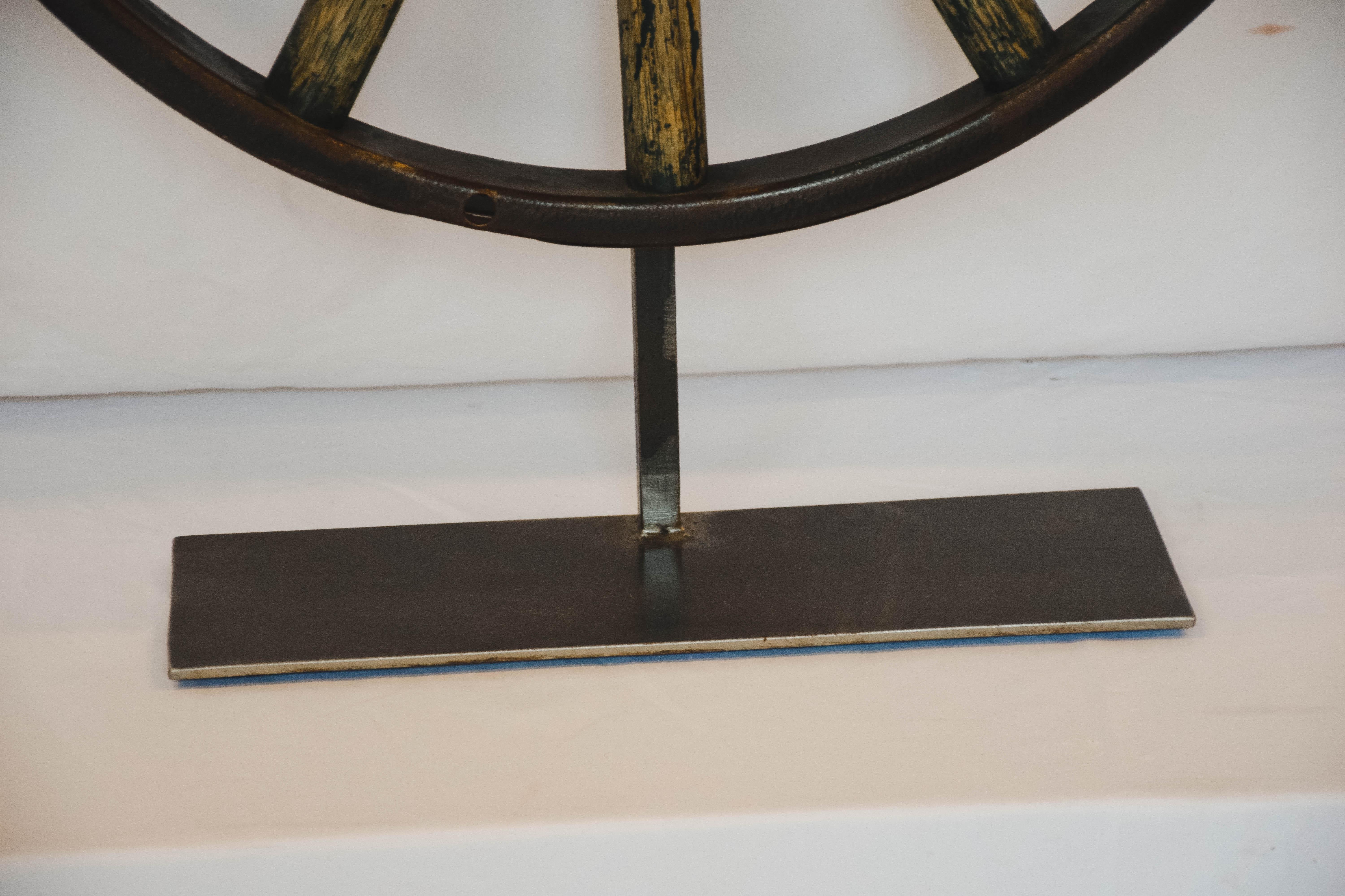 This Wagon wheel on an iron stand would be great as an accent or made into a lamp!
