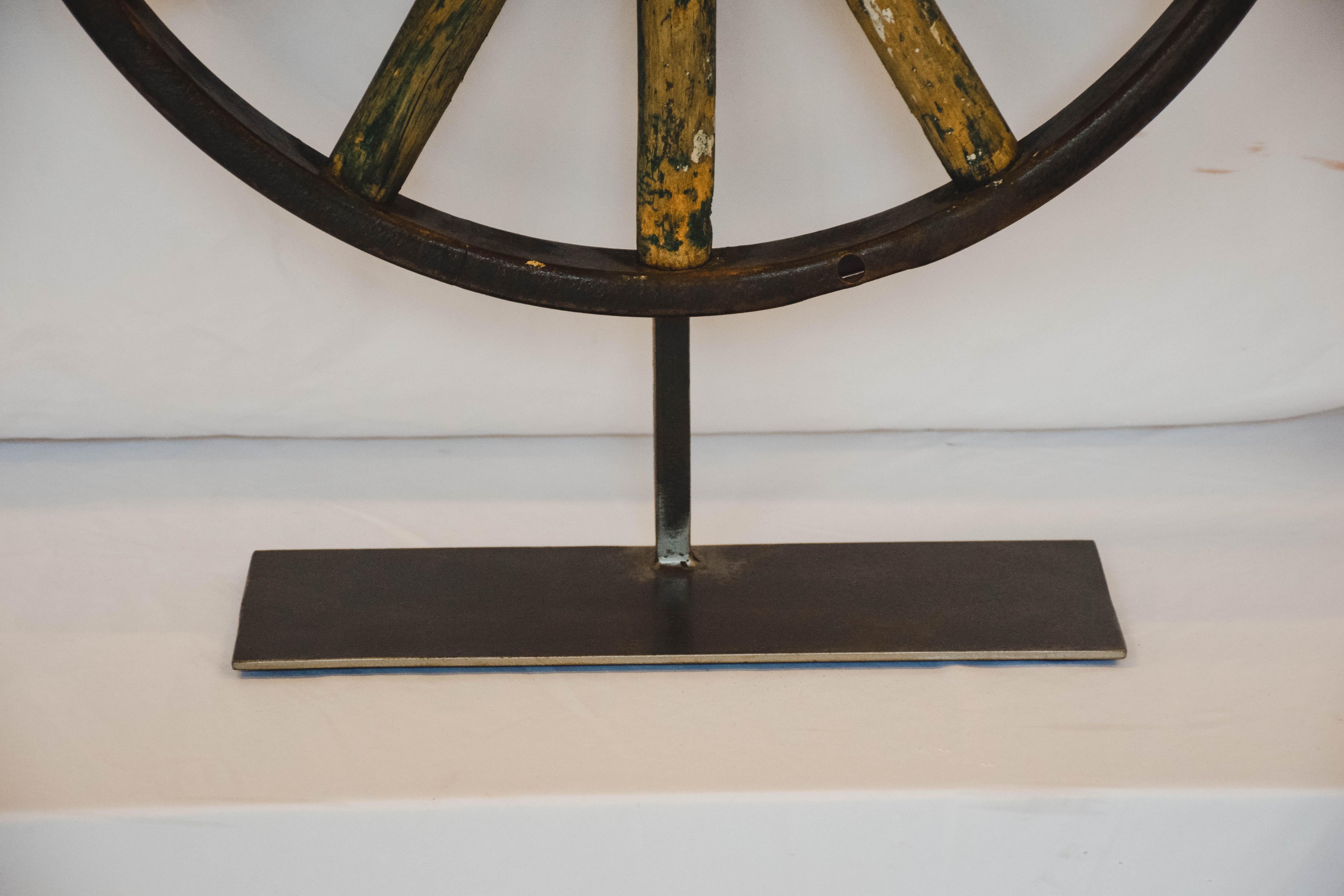 This wagon wheel on an iron stand would be great as an accent or made into a lamp!