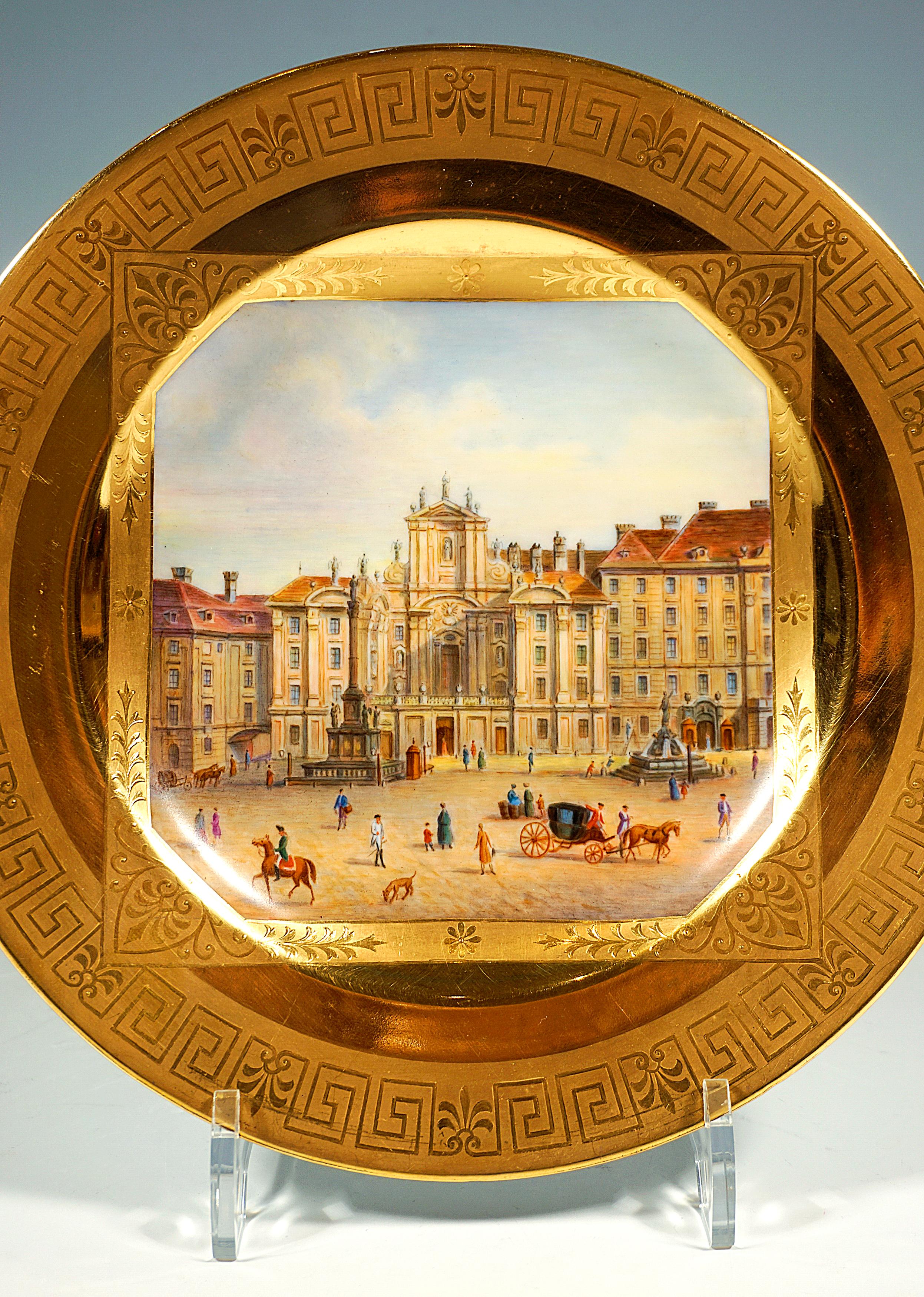 Lavishly decorated porcelain plate: Slightly concave plate, in the center large, square picture panel with beveled corners, framed by a rectangular cartouche with gold pastos on matt gold relief gold painting with stylized leaf motifs and tendrils,