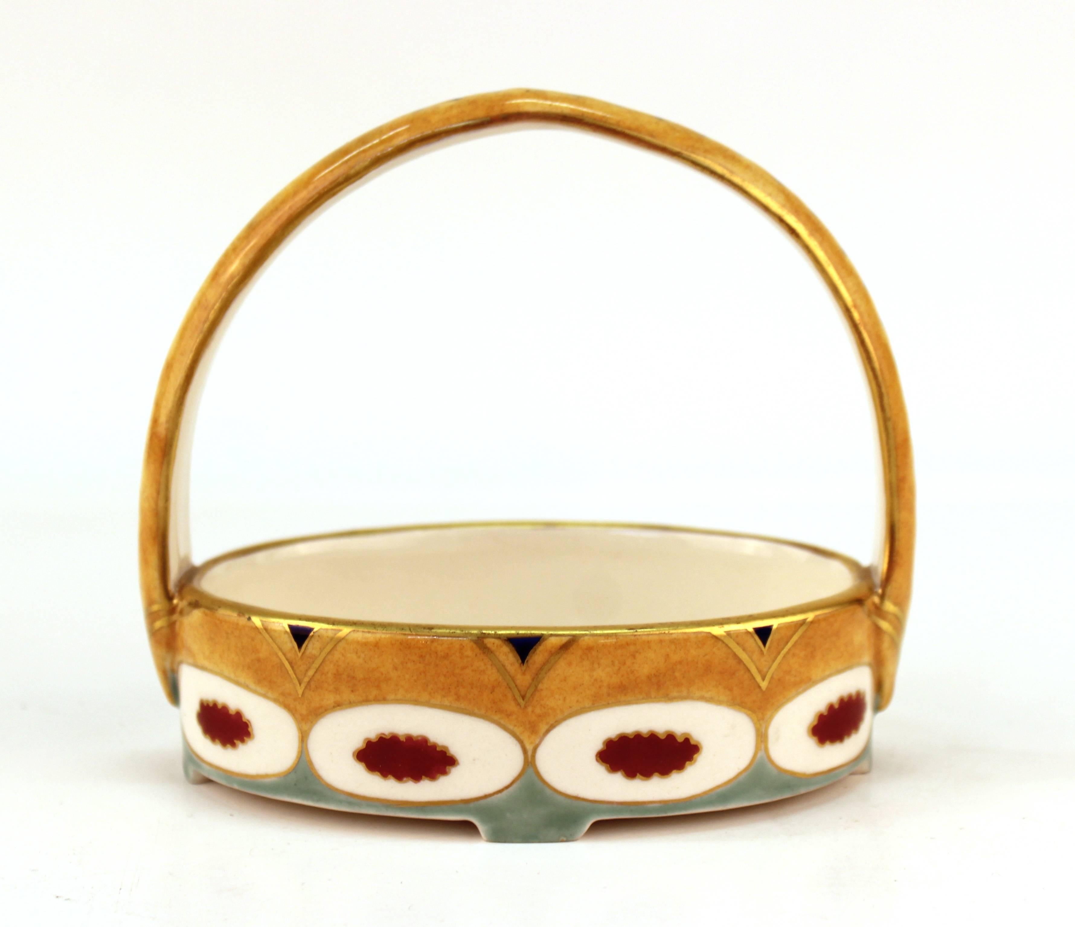 Wahliss Viennese Secession porcelain basket-form dish with gilt accents, designed by architect Karl Klaus in Vienna. Mark underneath. Minor wear to the glaze.