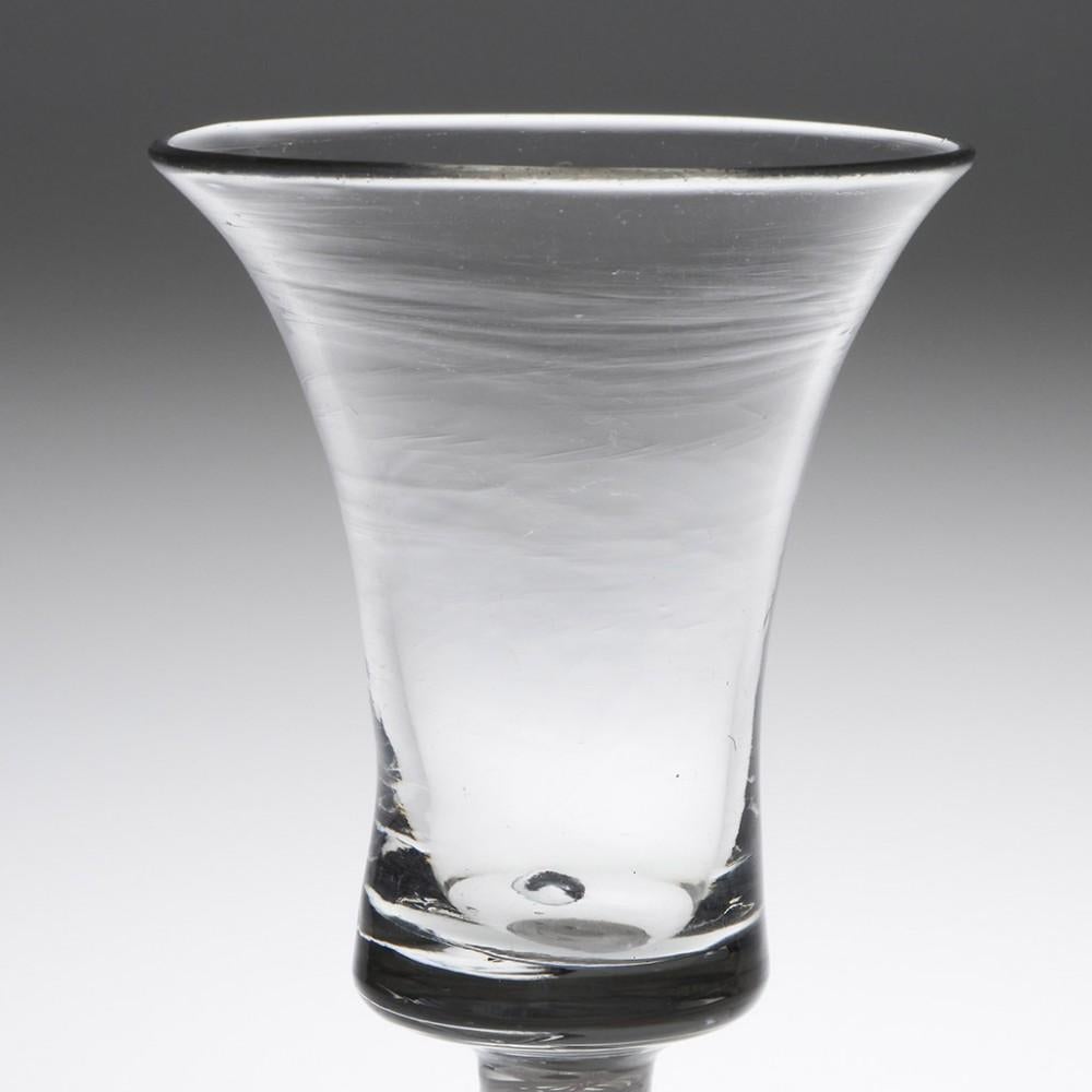 Heading : A Waisted Bucket Bowl Opaque Twist Stem Wine Glass
Period : George II- George III c1760
Origin : England
Colour : Clear
Bowl : Waisted bucket. The solid basal section contains an off centre air tear
Stem : A single series pair of lace