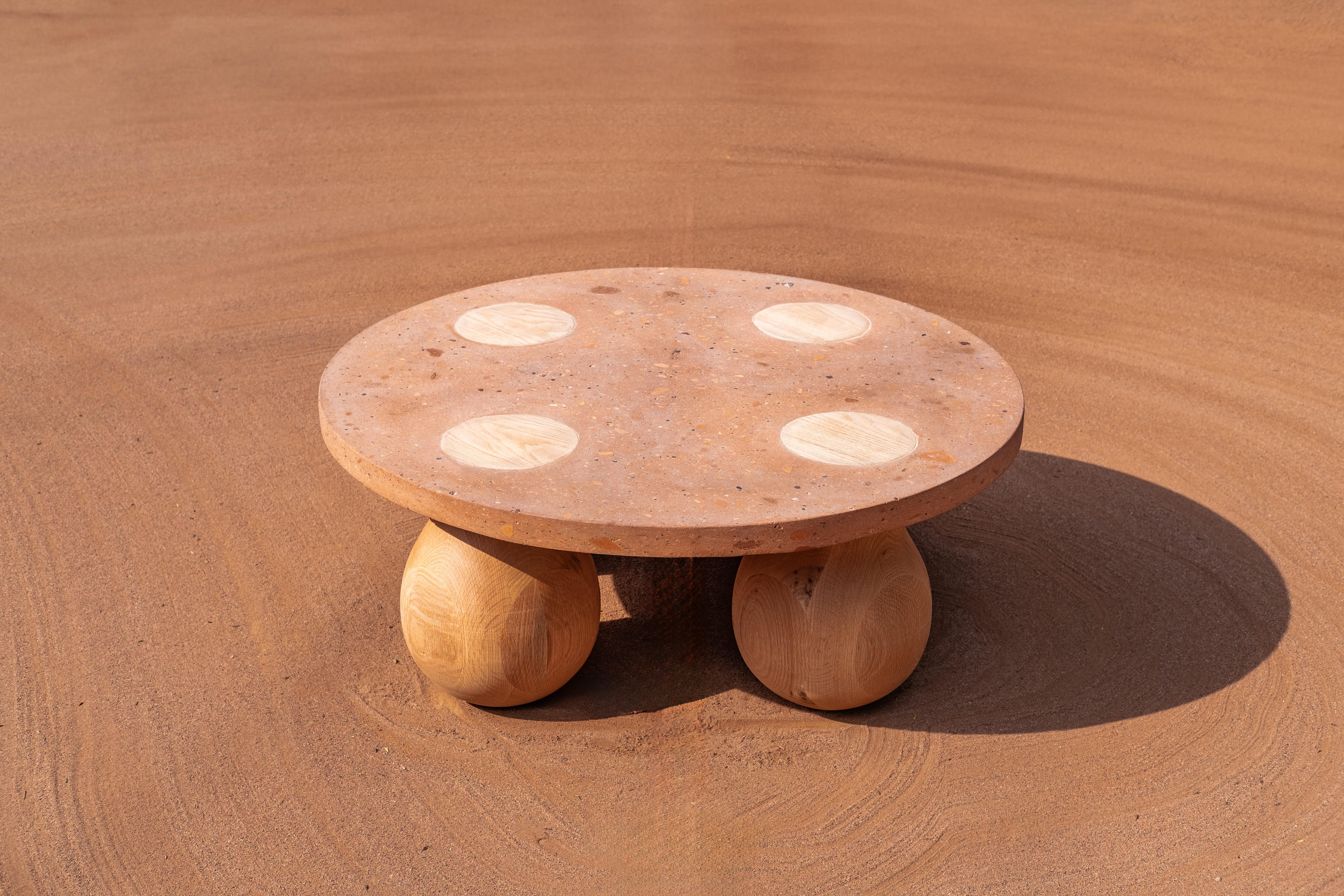 Waje Center Table by Comuna MX
Dimensions: W 90 x D 90 x H 43 cm
Materials: Orange Cantera Stone, Oak Wood.  
Weight: 70 Kg.

Some parts of this product are handmade, so they may vary in color, shape, texture, and size.
Some parts of this product