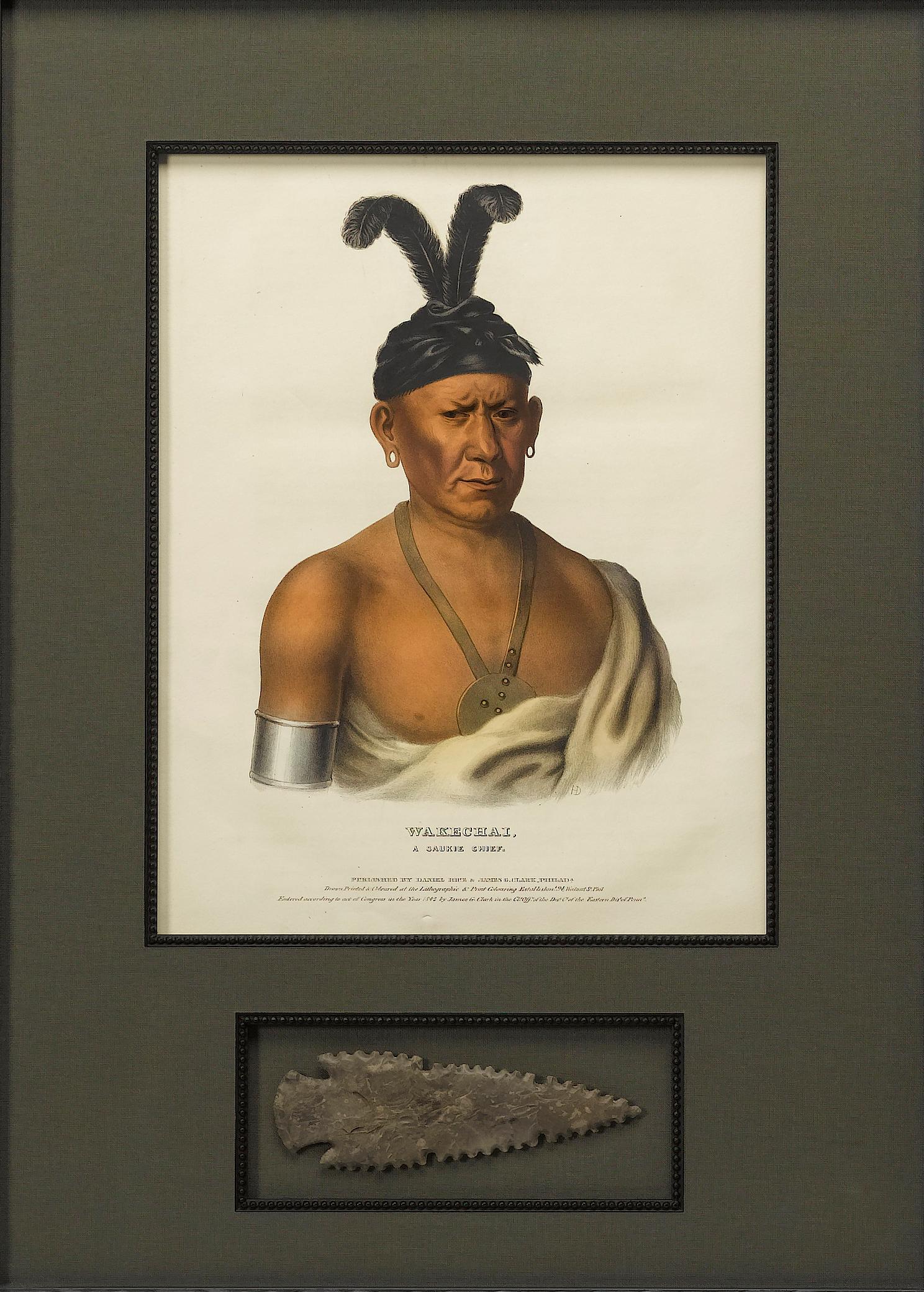 This is a remarkable lithographic portrait of Wakechai, A Saukie, from McKenney and Hall’s three-volume work, Indian Tribes of North America. This portrait was printed in 1842 and is paired with an antique Native American arrowhead.

Wakechai, or