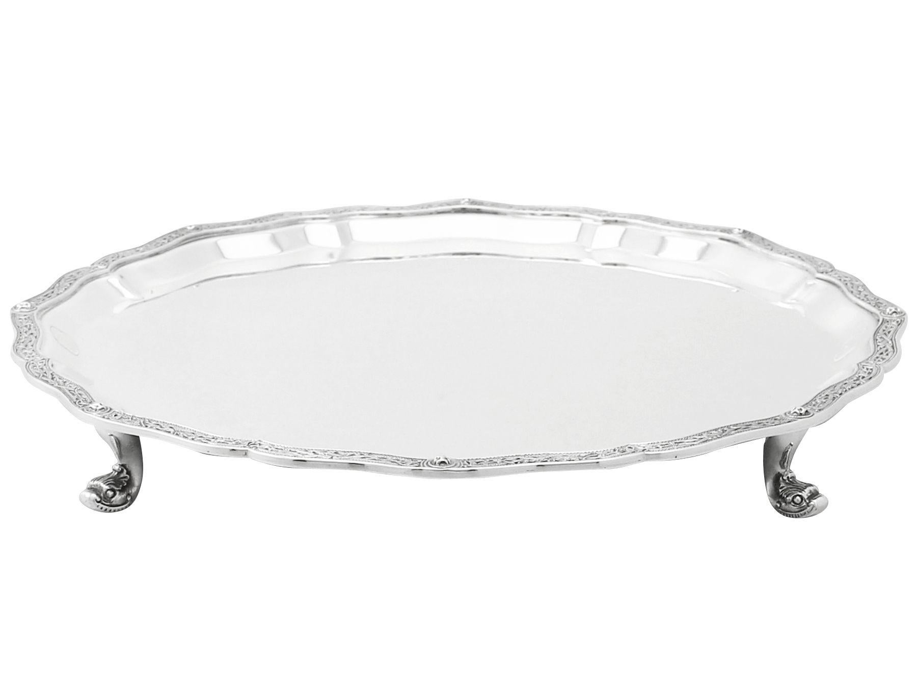 An exceptional, fine and impressive vintage Elizabeth II English sterling silver salver in the Lindisfarne style; an addition to our dining silverware collection.

This exceptional vintage Elizabeth II sterling silver salver has a plain circular