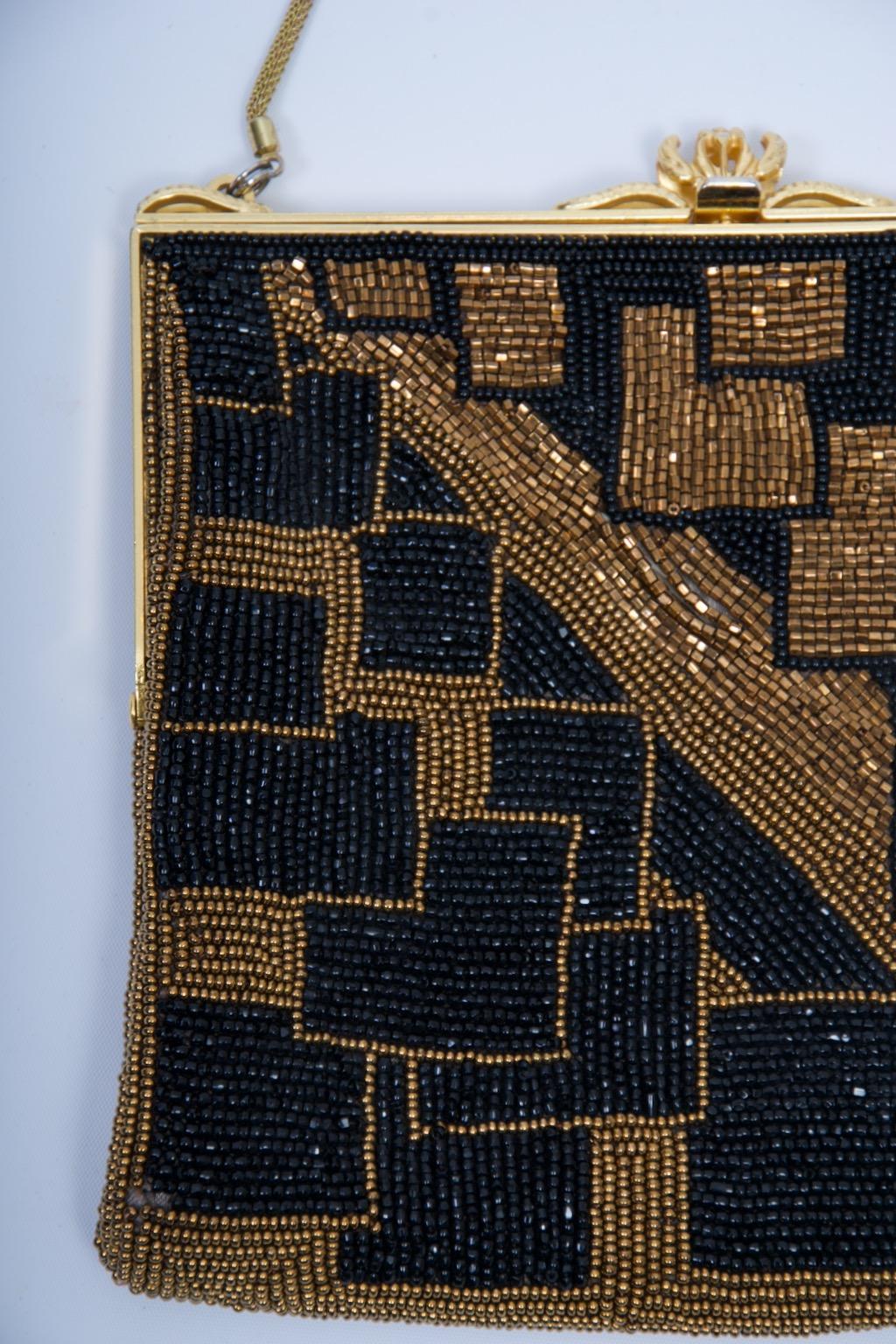 Walborg Art Deco inspired evening bag composed of black and gold beads, both reflective bugle beads and mat seed beads, arranged in a geometric pattern of squares and rectangles. Both front and back sides are basically divided into upper right and