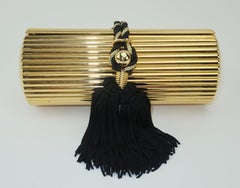 Walborg Gold Metal Cylinder Handbag With Black Tassel Closure