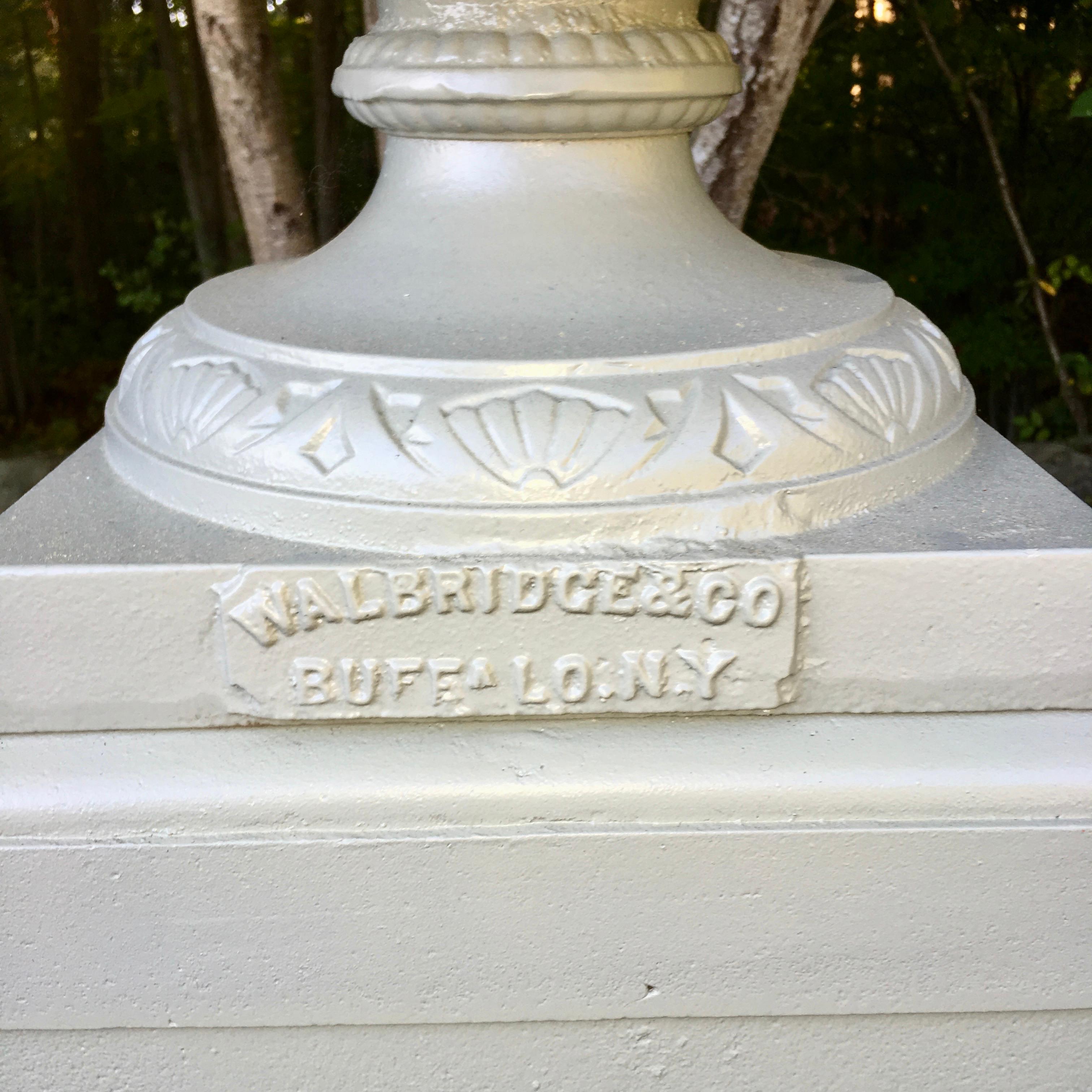 Large scale cast iron urn with handles on multi-tiered plinth base produced by the Walbridge Company of Buffalo, NY, circa 1900. See image 4 for detailed dimensions. Urn and plinths have been professionally sandblasted and powder coated a light