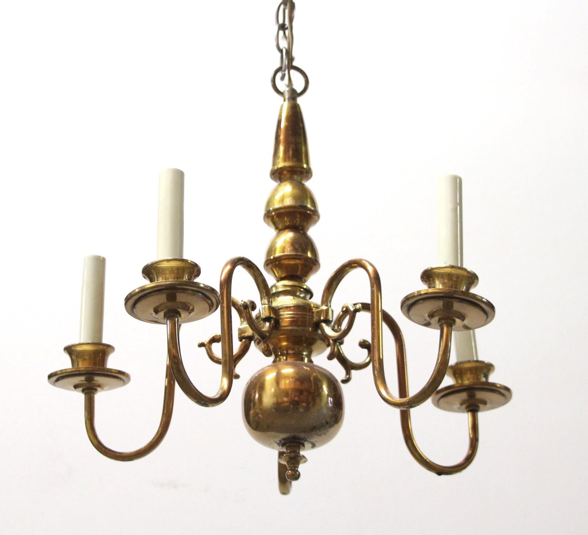 Simple 20th century brass 5 arm chandelier with copper finish originally from the 39th floor of the Waldorf Astoria Hotel on Park Ave in NYC. Waldorf Astoria authenticity card included with your purchase. This light has not been restored. Please