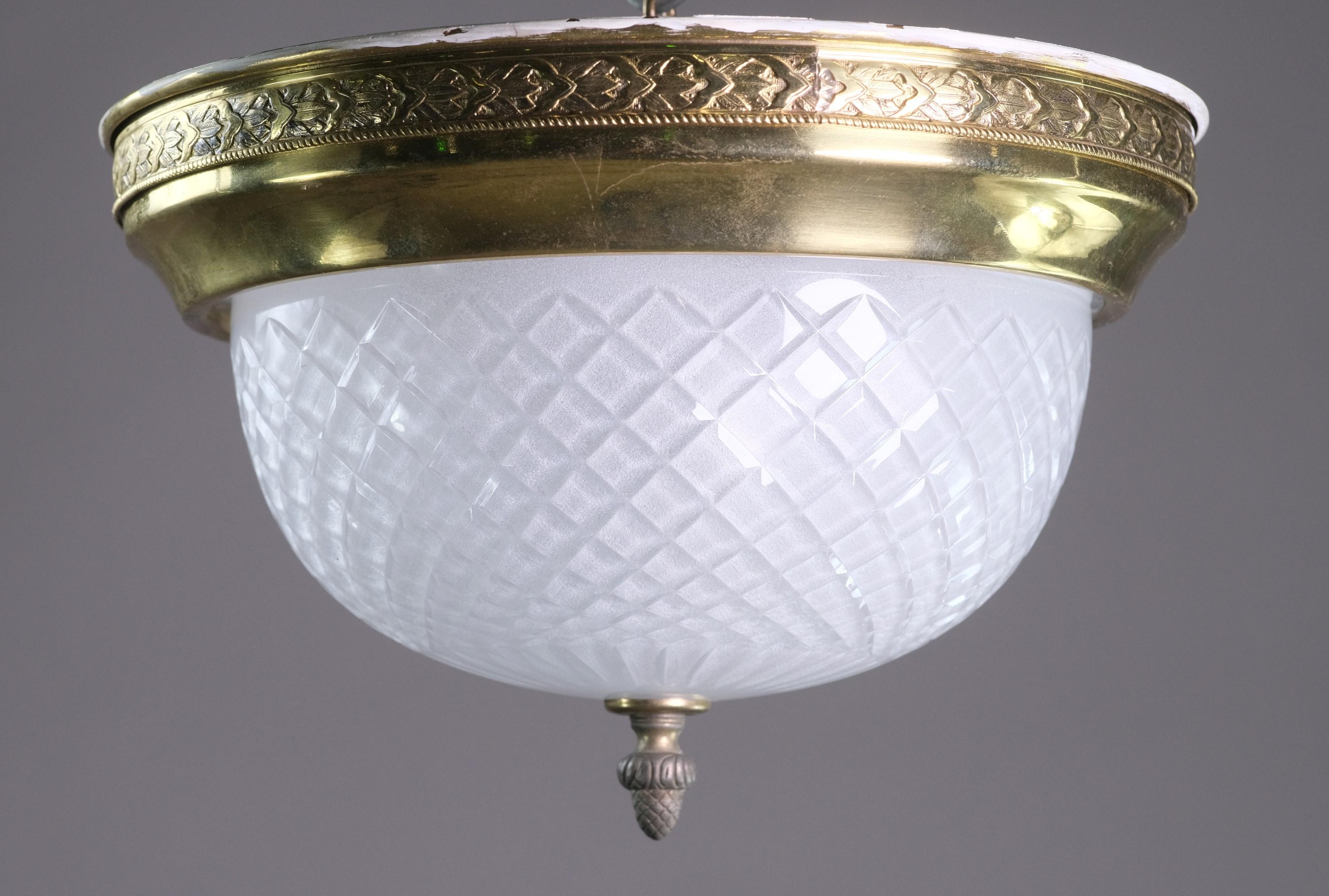 20th Century flush mount light retrieved from the suites of the NYC Waldorf Astoria Hotel. Brass ceiling pan and frosted cut glass shade. Bottom features a pineapple finial. A Waldorf Astoria authenticity card is included with your purchase. This