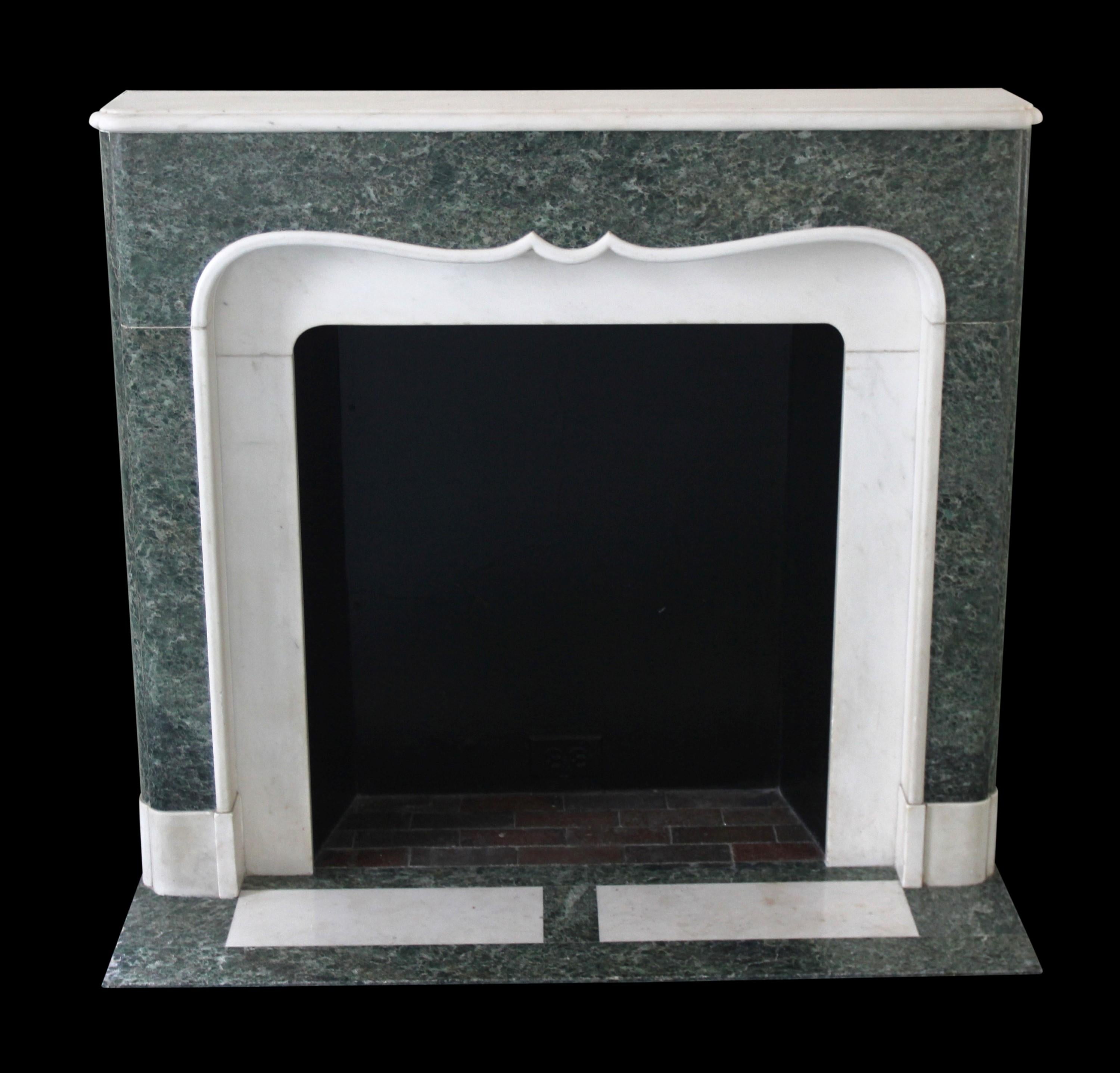A distinctive mantel in a striking green and white statuary marble design, sourced from the historic Waldorf Astoria. Accompanying this mantel is a complementary paneled hearth, creating a harmonious ensemble. The standout feature of this mantel is