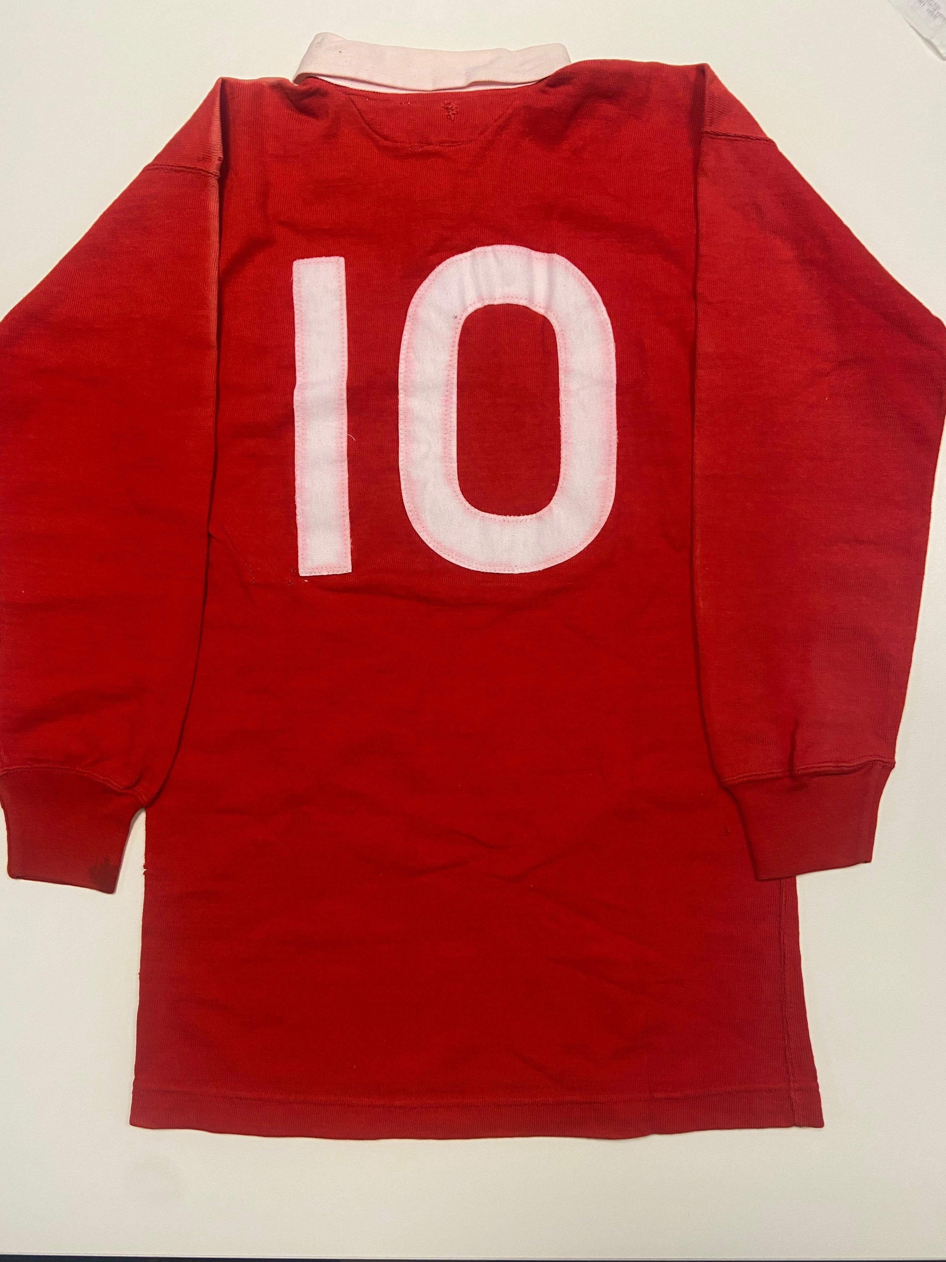 A red #10 Wales rugby shirt, worn by Ian Lewis vs. Canada in Toronto in 1973.
A hugely rare piece of Welsh rugby history. Wales match-issue shirts rarely appear for sale - especially those from the coveted golden era of the 70s.

Incredibly unusual: