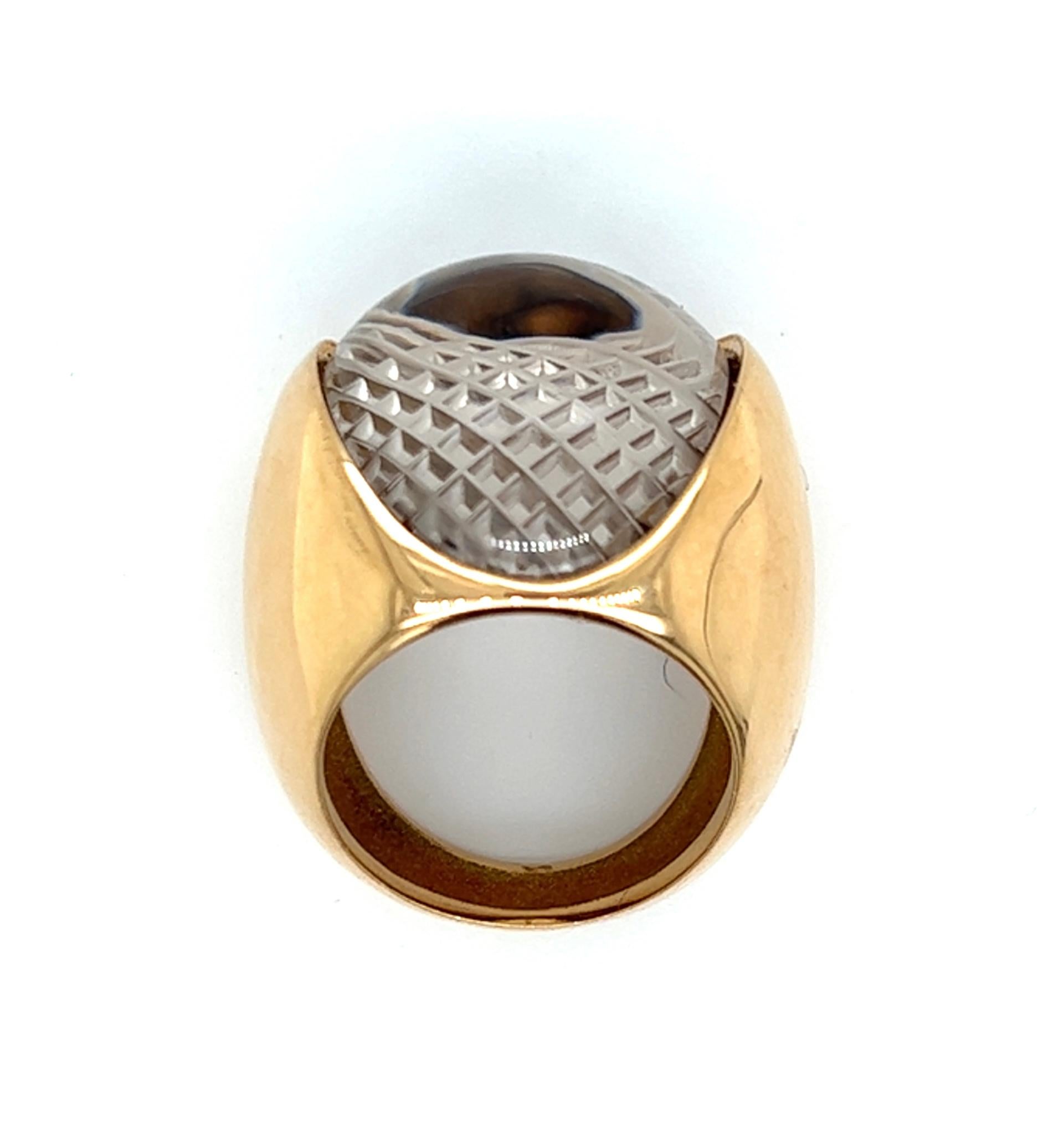 One carved rock crystal limited edition ring in 14 karat yellow gold is one of eight made of this design. The ring is stamped 