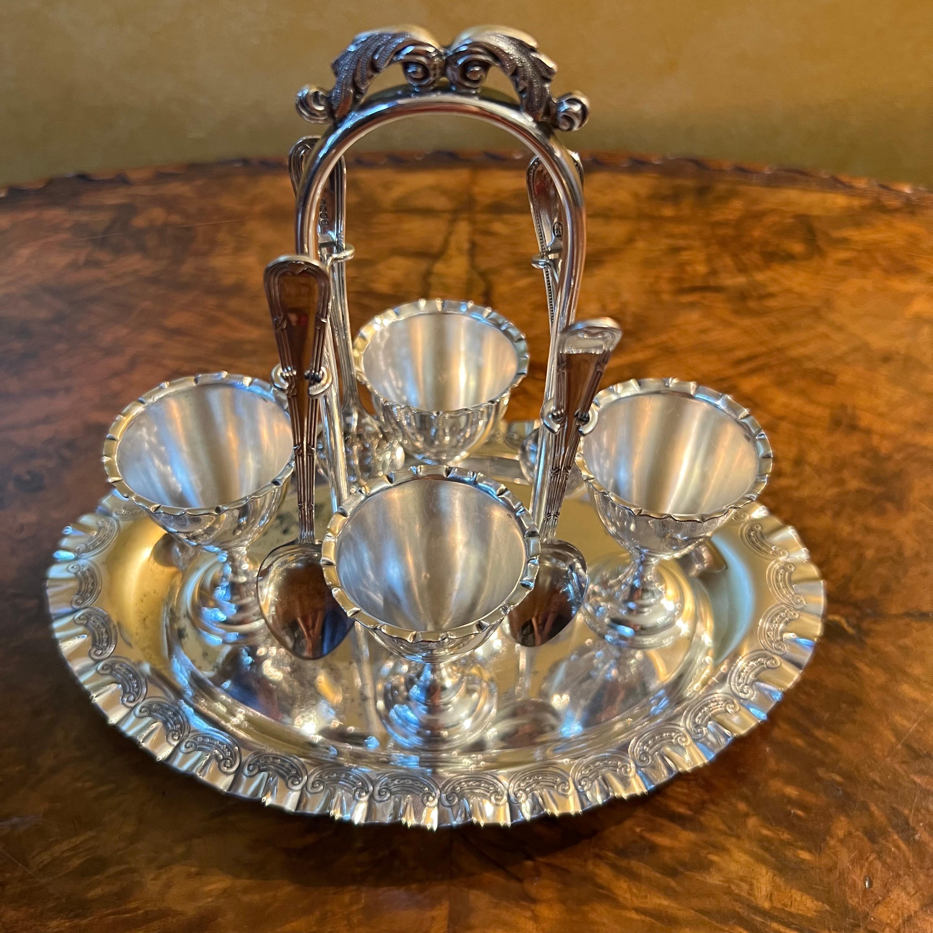 Set of four cups and four spoons, spoons are not all the same. there is marks and ware to the tray, there is slight ware to cups from age and use

Material: Silver Plated

Measurements:  18cm high, 21cm length, 13cm width

Country of Origin: England